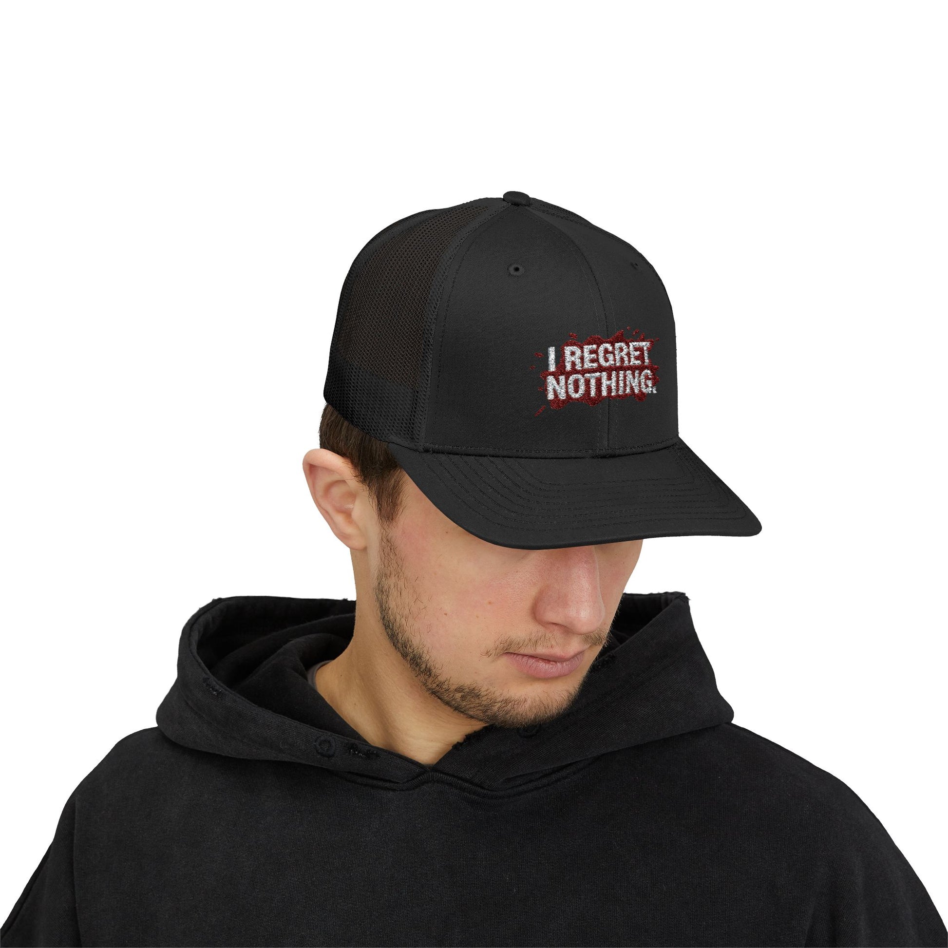 Person wearing a black cap with 'I Regret Nothing' text on a white background