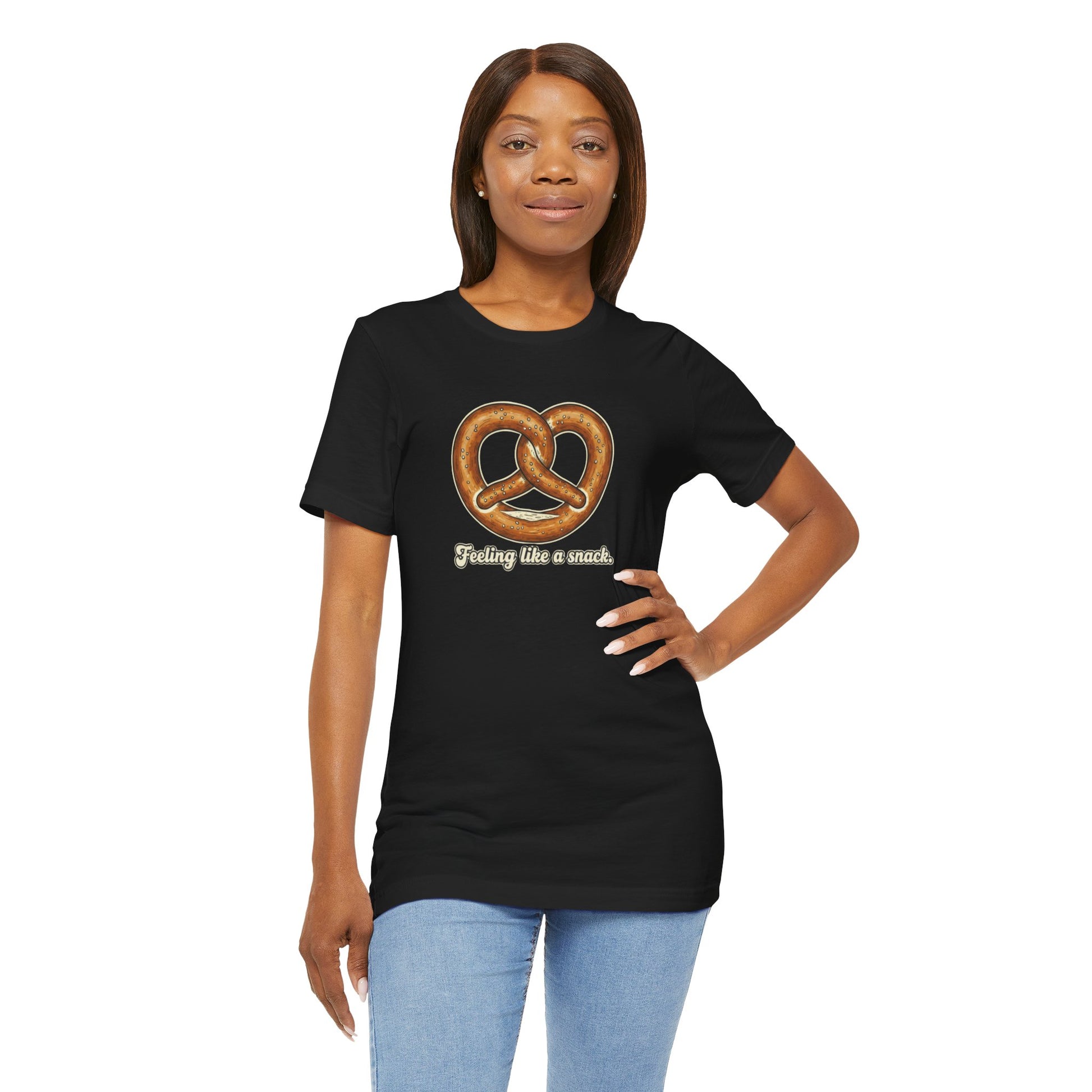 Woman wearing a black t-shirt with a pretzel graphic and text 'Feeling like a snack' on a white background