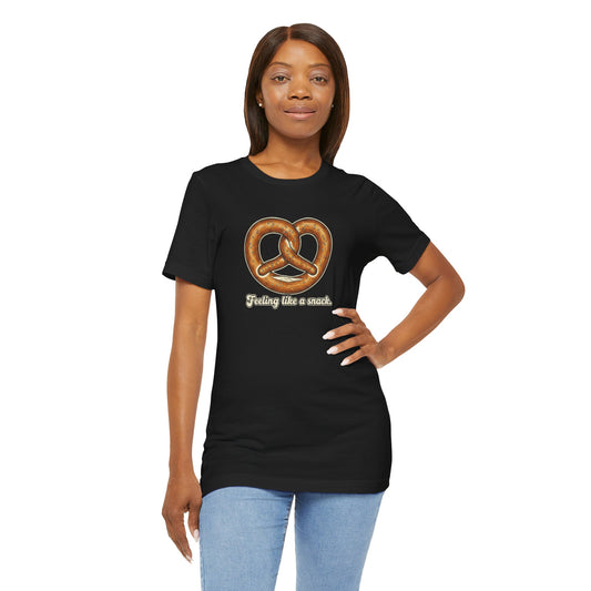 Woman wearing a black t-shirt with a pretzel graphic and text 'Feeling like a snack' on a white background