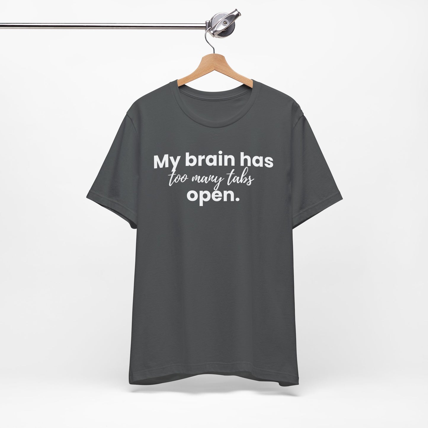 Gray t-shirt with 'My brain has too many tabs open' text on a hanger against a white background