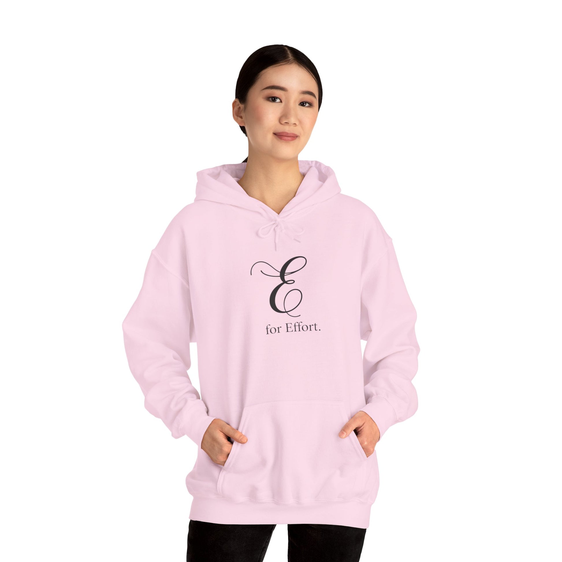 Person wearing a pink hoodie with 'E for Effort' text on a white background