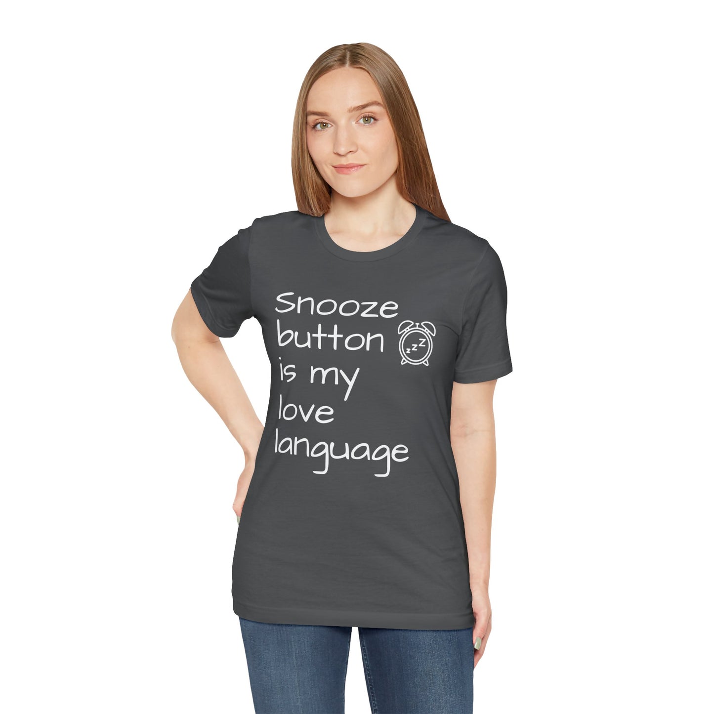 Woman wearing a dark gray t-shirt with text 'Snooze button is my love language' on a white background