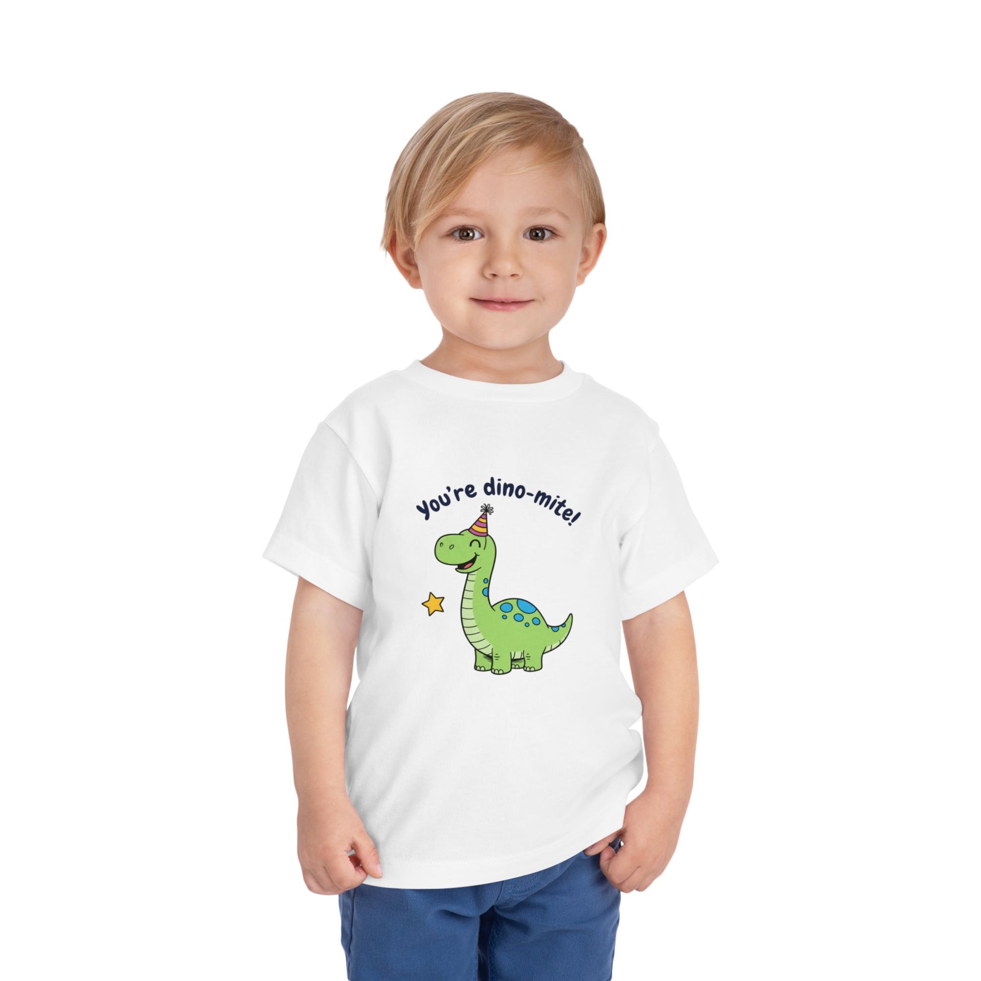 Child wearing a white t-shirt with a dinosaur graphic and text on a white background