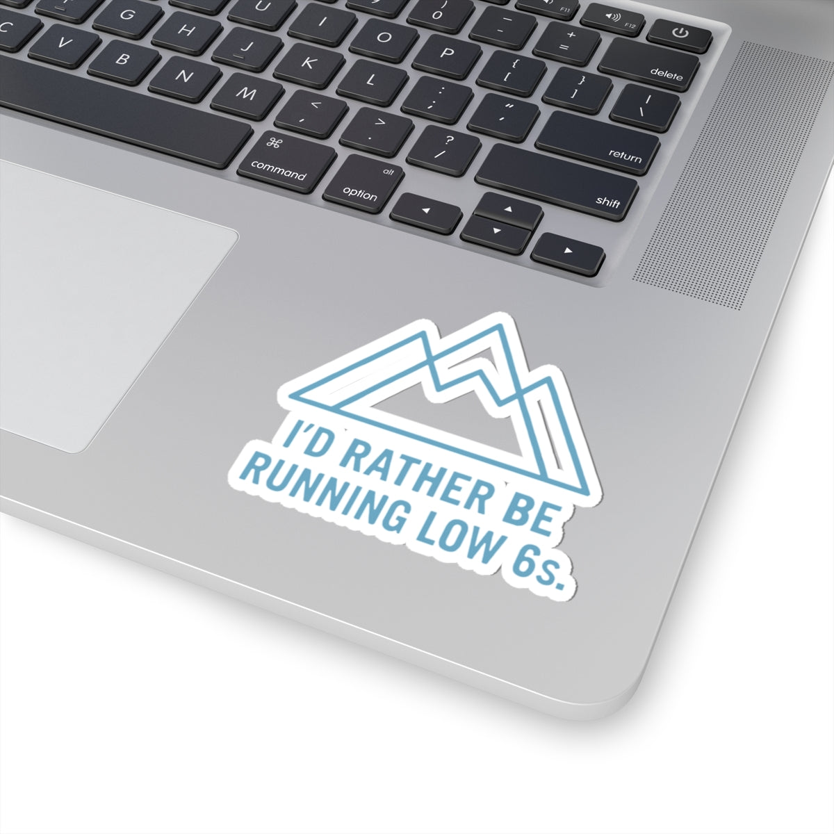 Laptop with a sticker reading 'I'd rather be running low 6s' on a white background