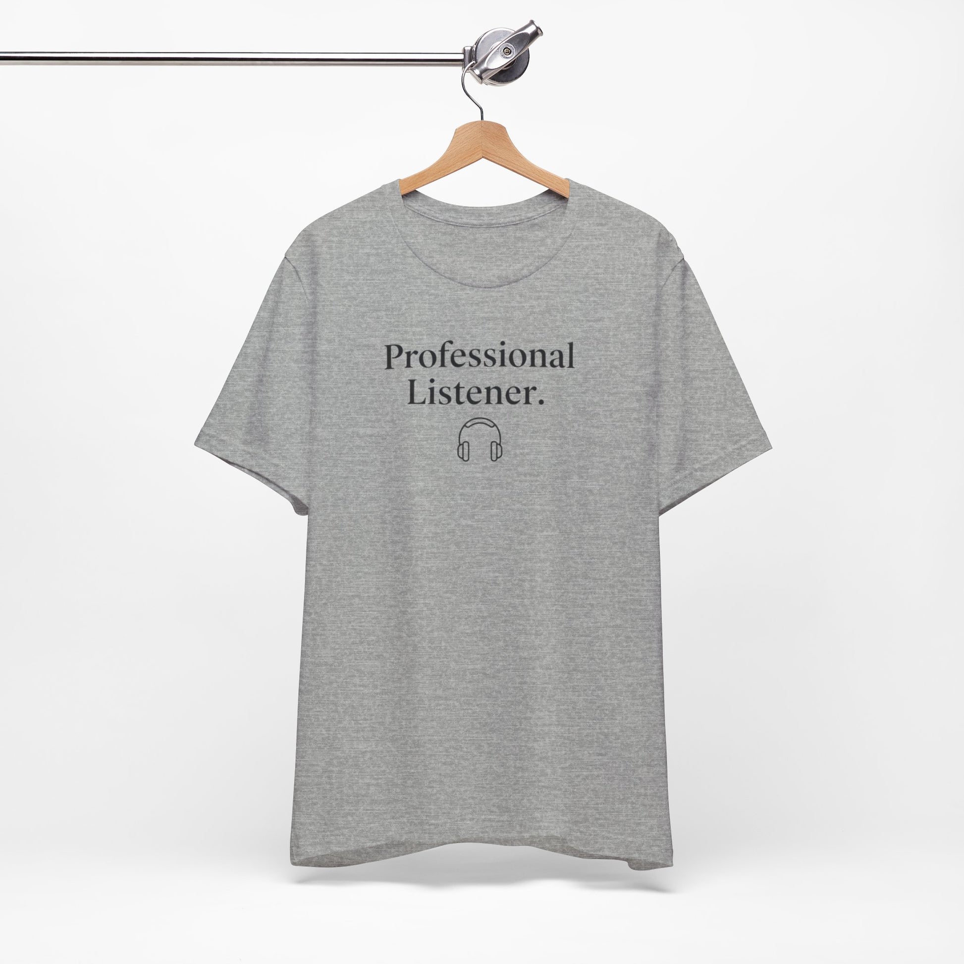 Gray t-shirt with 'Professional Listener' text on a hanger against a white background