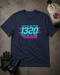 A navy blue graphic t-shirt laid flat on a textured gray concrete surface, surrounded by black work gloves, a black funnel, and a plastic jug. The t-shirt features a colorful retro-style graphic with the text 'LIFE IS BETTER 1320 FEET AT A TIME' in cyan and pink.