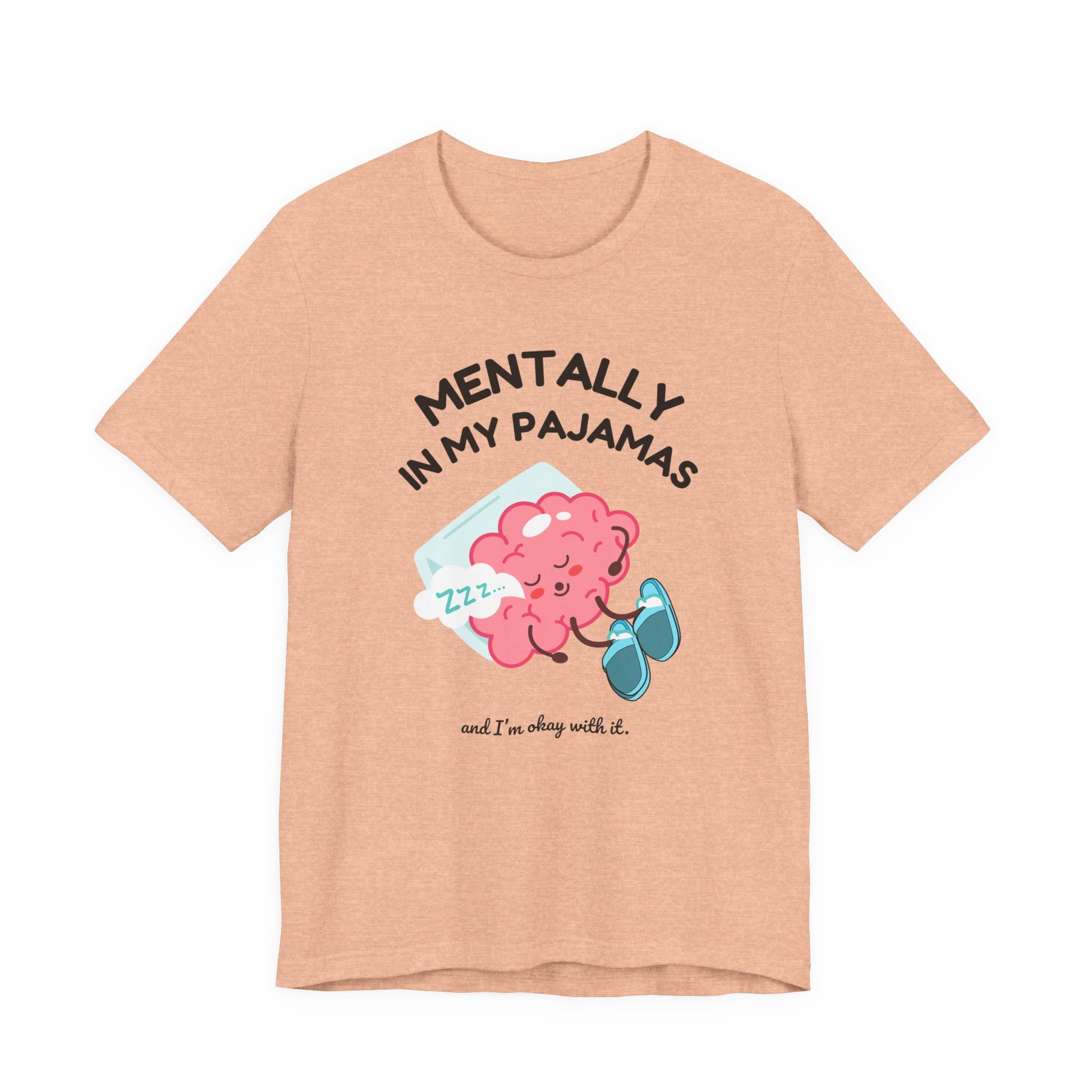 Peach t-shirt with a cartoon brain design and text 'Mentally in my pajamas and I'm ok with it' on a white background