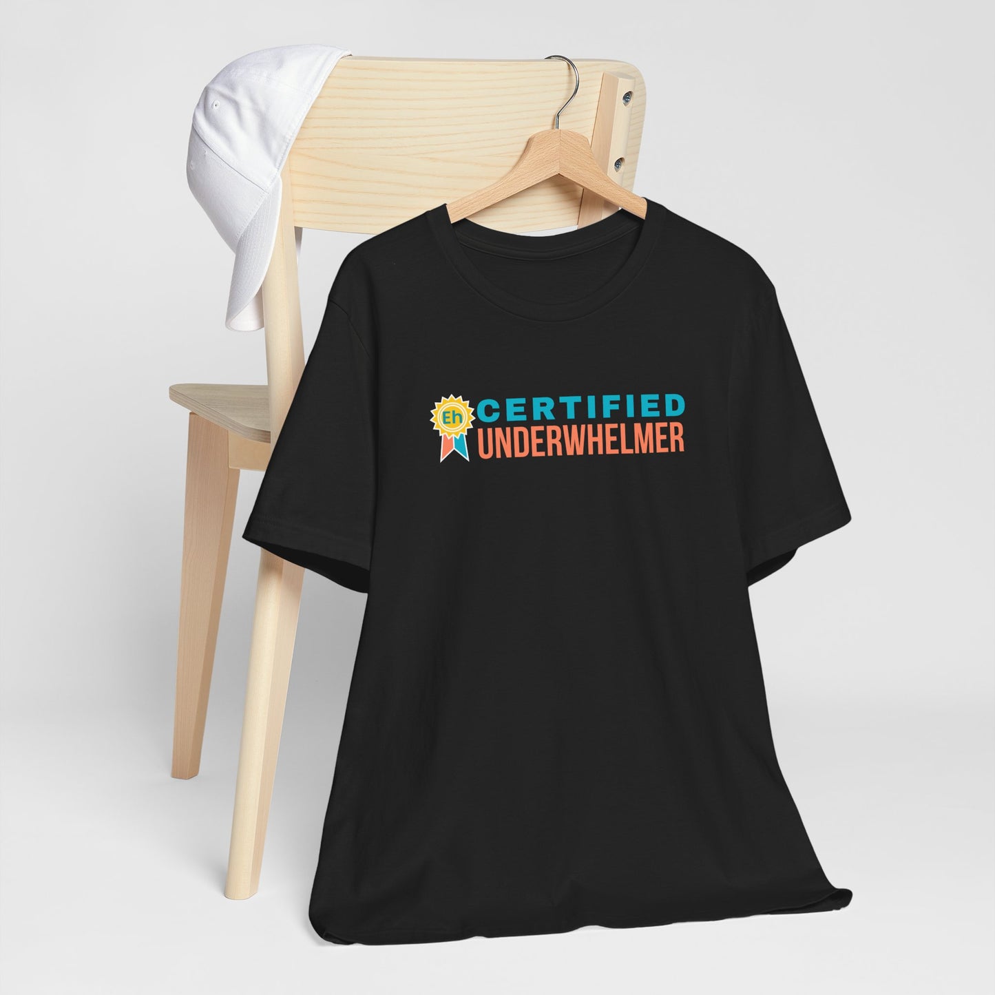 Black t-shirt with 'Certified Underwhelmer' text on a white background
