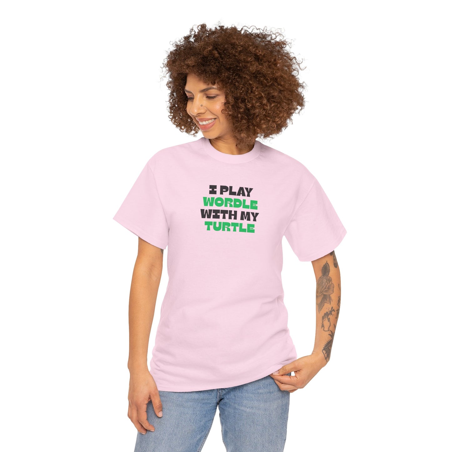 Person wearing a pink t-shirt with text 'I play wordle with my turtle' on a white background