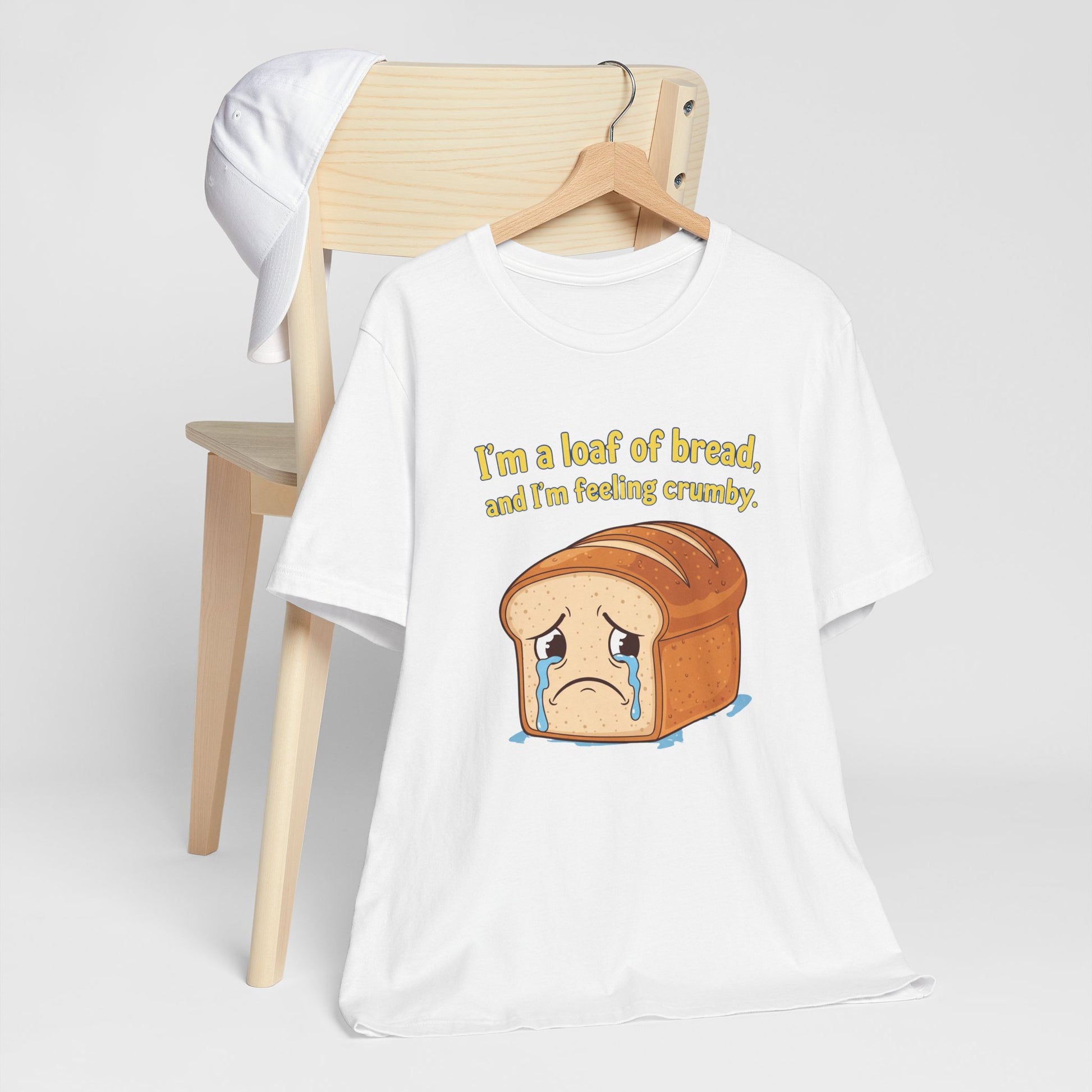 White Bella+Canvas 3001 t-shirt with bread graphic and text on a white background. The text says, "I'm a loaf of bread, and I'm feeling crumby."