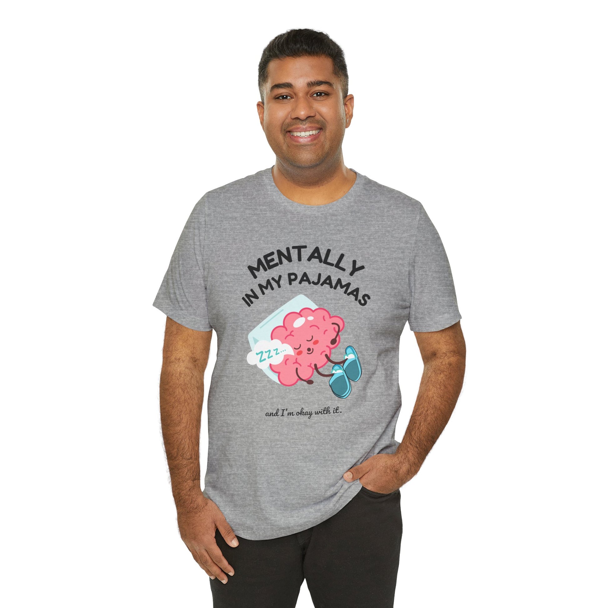 Man wearing a gray t-shirt with a graphic and text 'Mentally in my pajamas and I'm ok with it' on a white background