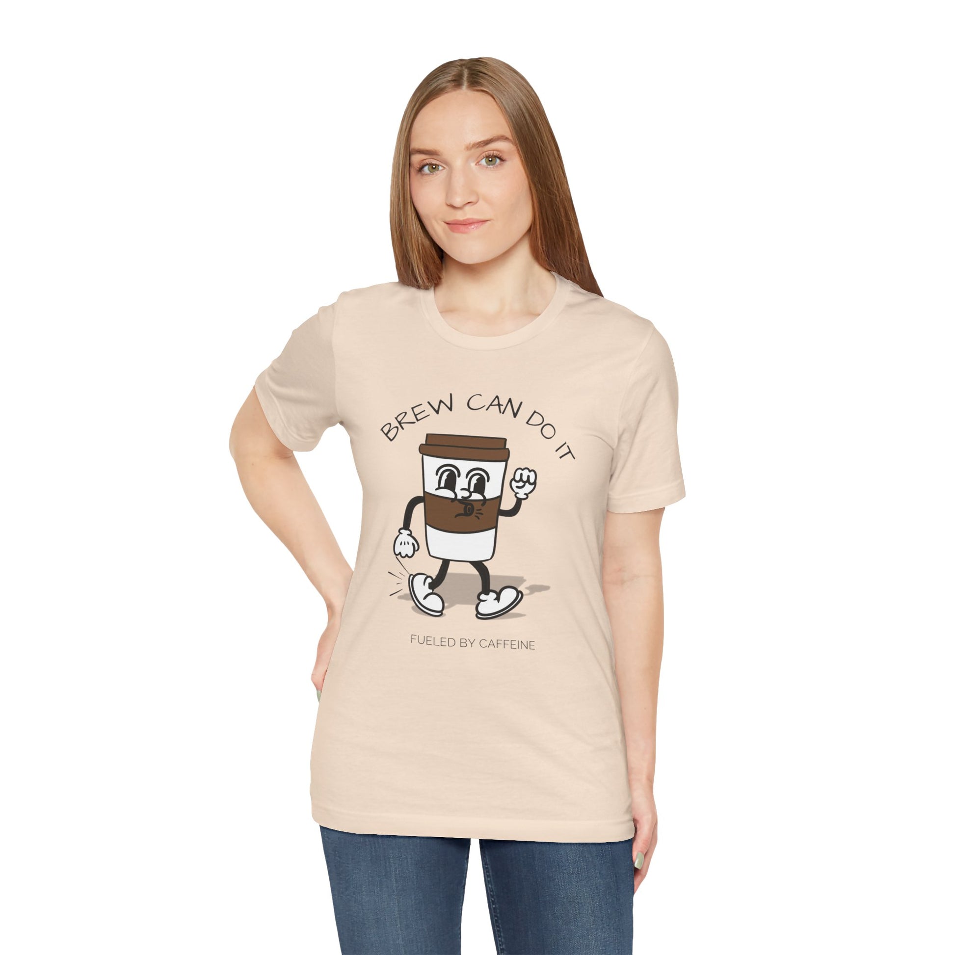 Woman wearing a beige t-shirt with a coffee-themed graphic design and text 'Brew Can Do It Fueled By Caffeine' on a white background