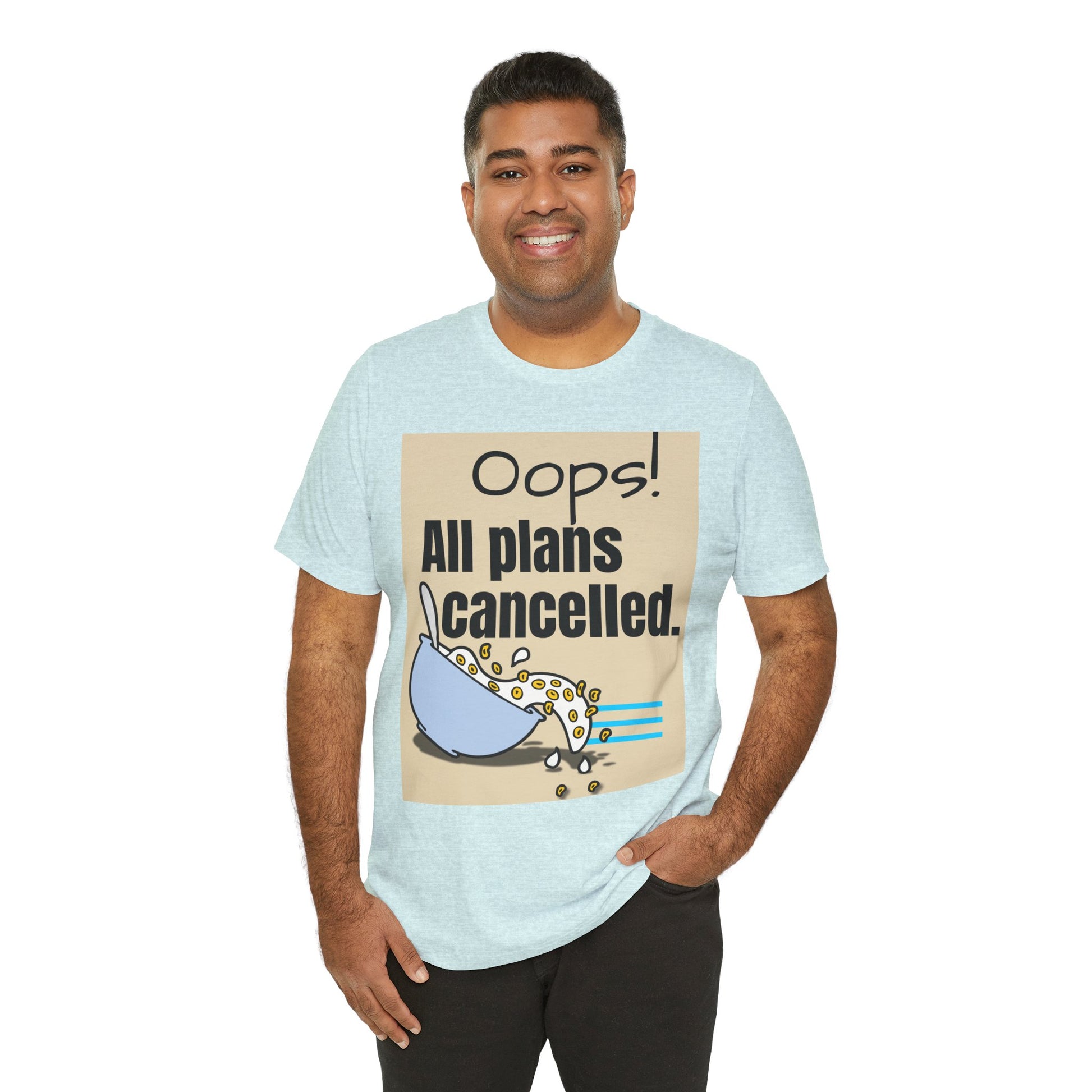 Man wearing a light blue t-shirt with a graphic and text 'Oops! All plans cancelled.'