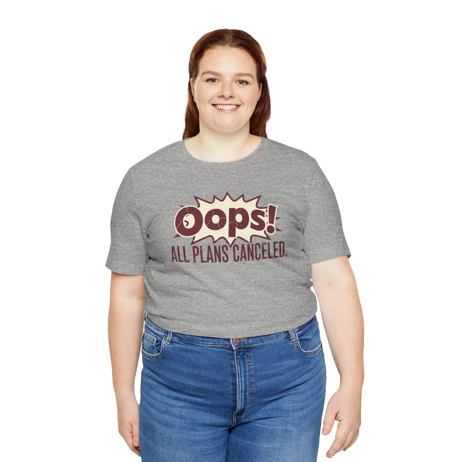 Person wearing a gray t-shirt with 'Oops! All Plans Canceled' text on a white background