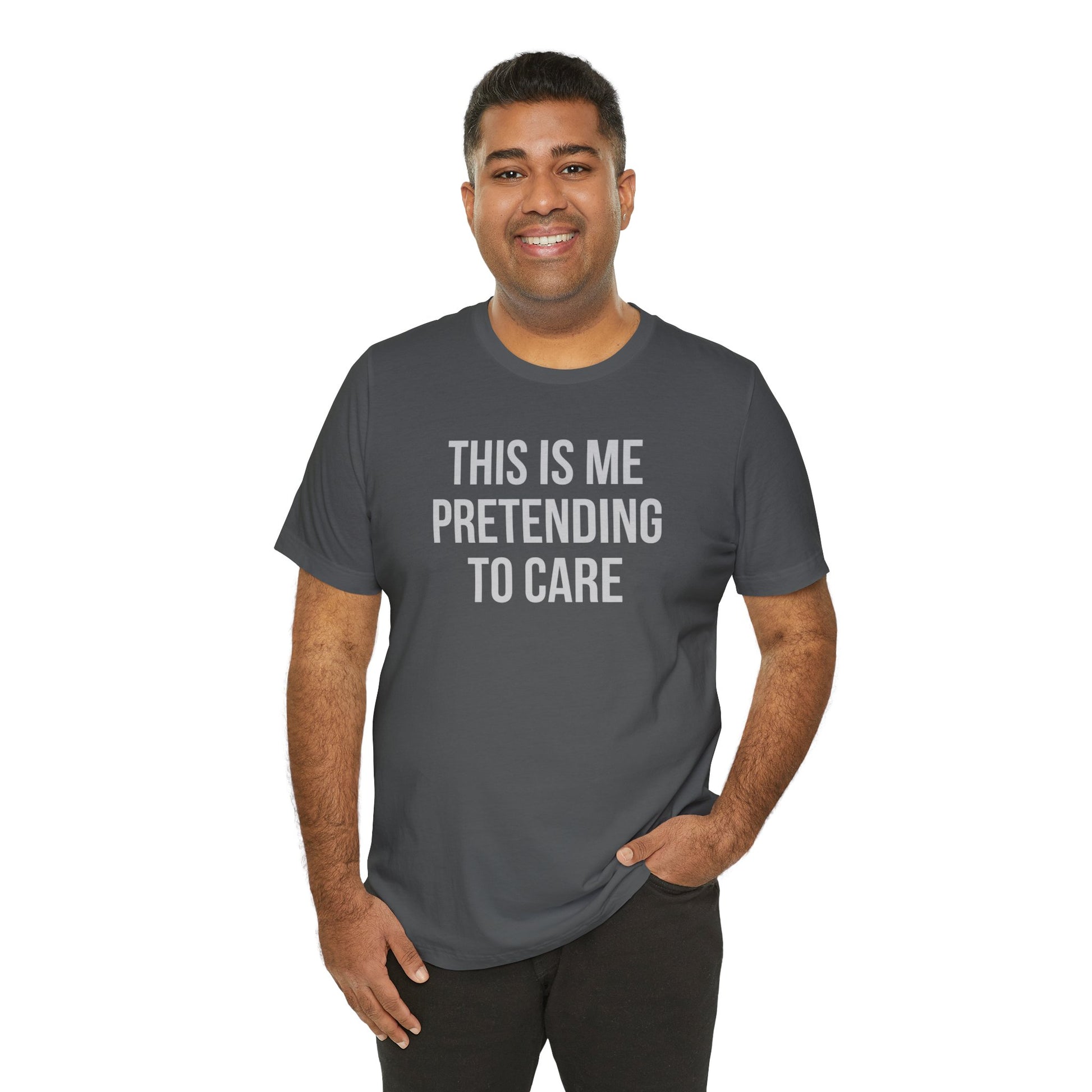 Man wearing a gray t-shirt with text 'This is me pretending to care' on a white background