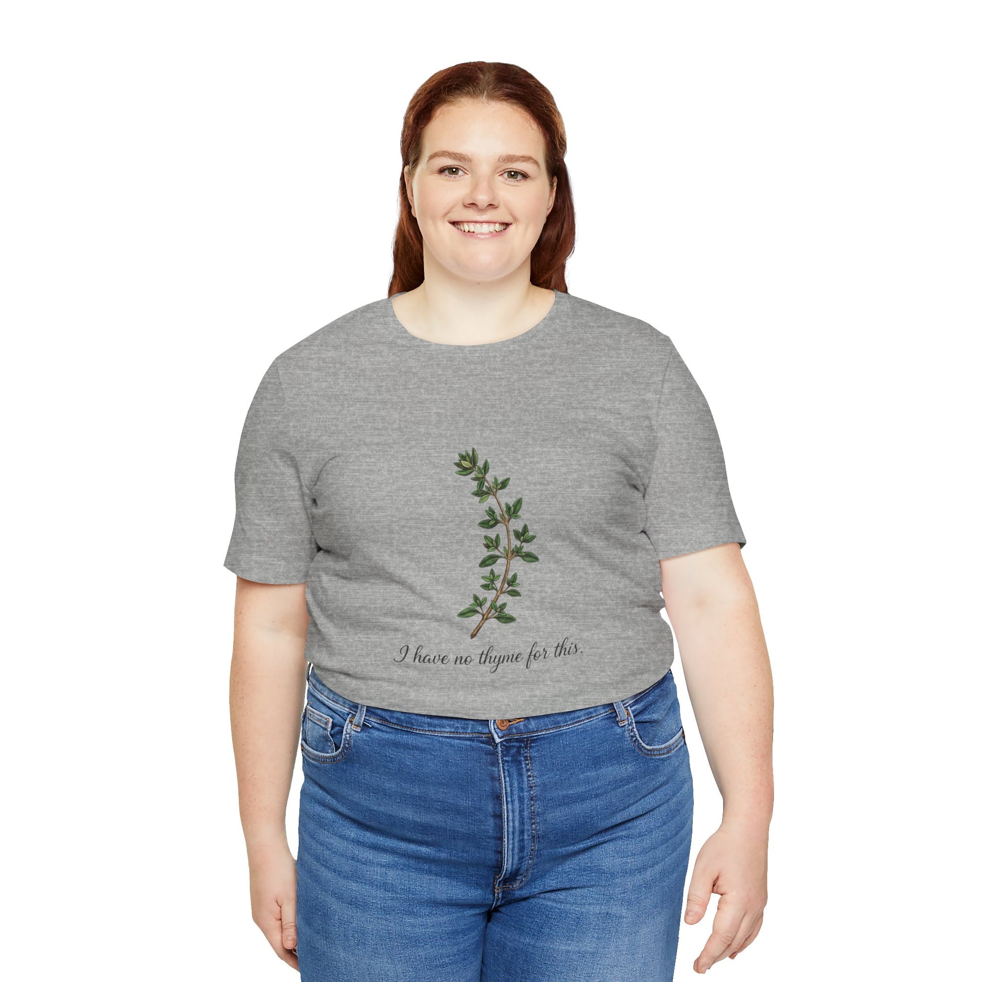 Person wearing a gray t-shirt with a plant design and text 'I have no thyme for this' on a white background