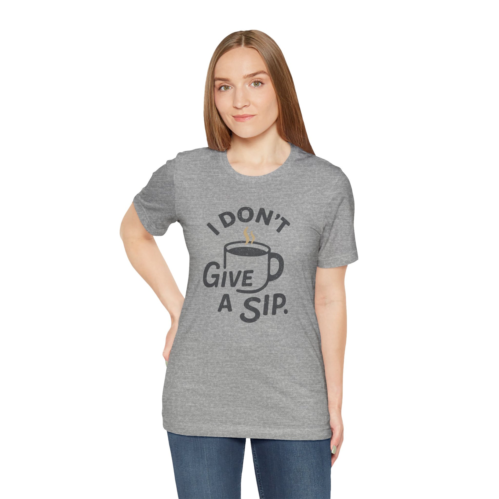 Woman wearing a gray t-shirt with a coffee-themed graphic and 'I don't give a sip' text.