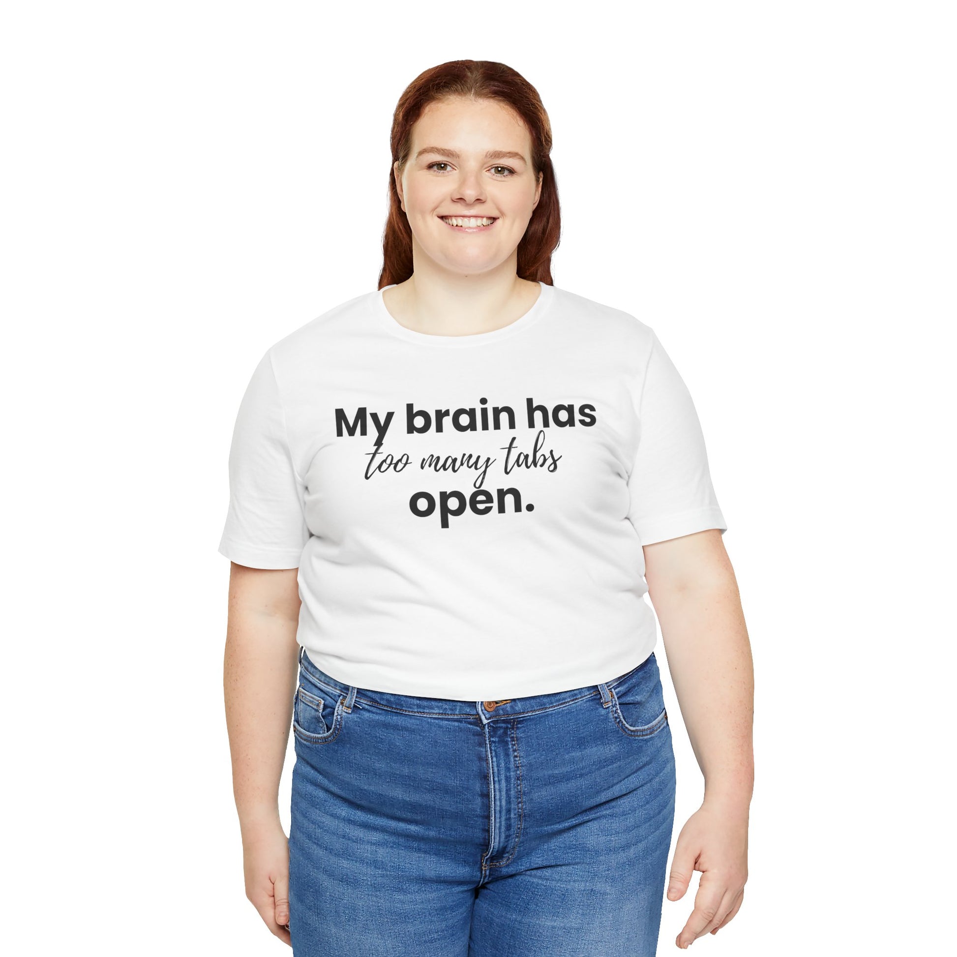 Person wearing a white t-shirt with text 'My brain has too many tabs open' on a white background