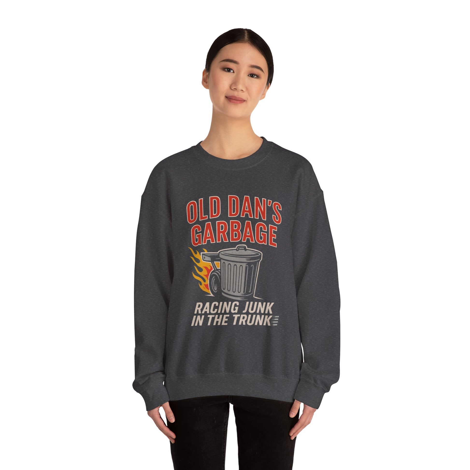Young woman wearing a dark heather Gildan 18000 sweatshirt with Old Dan's Garbage Racing Junk in the Trunk graphic.