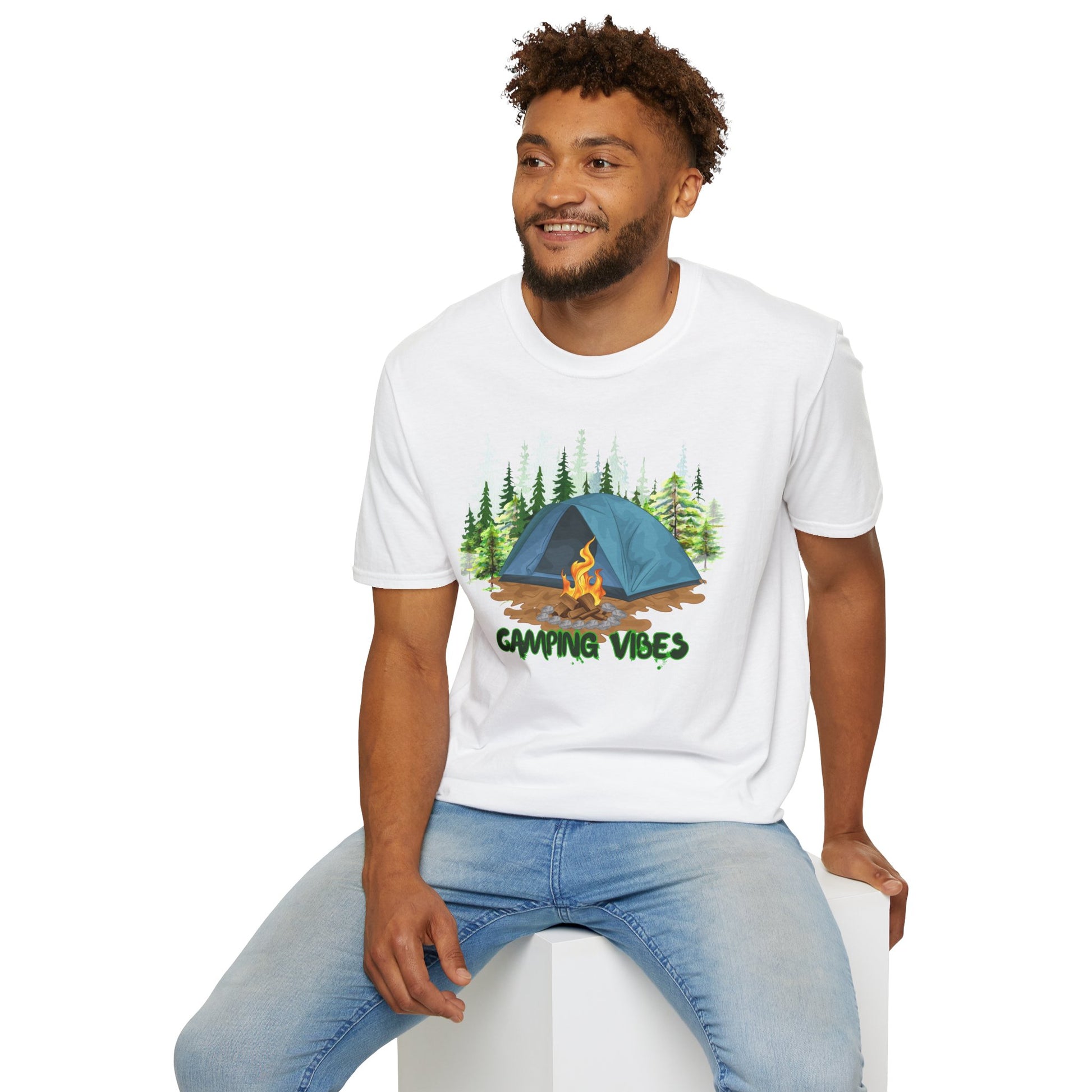 Man wearing a white t-shirt with a 'Camping Vibes' design, sitting on a white stool.