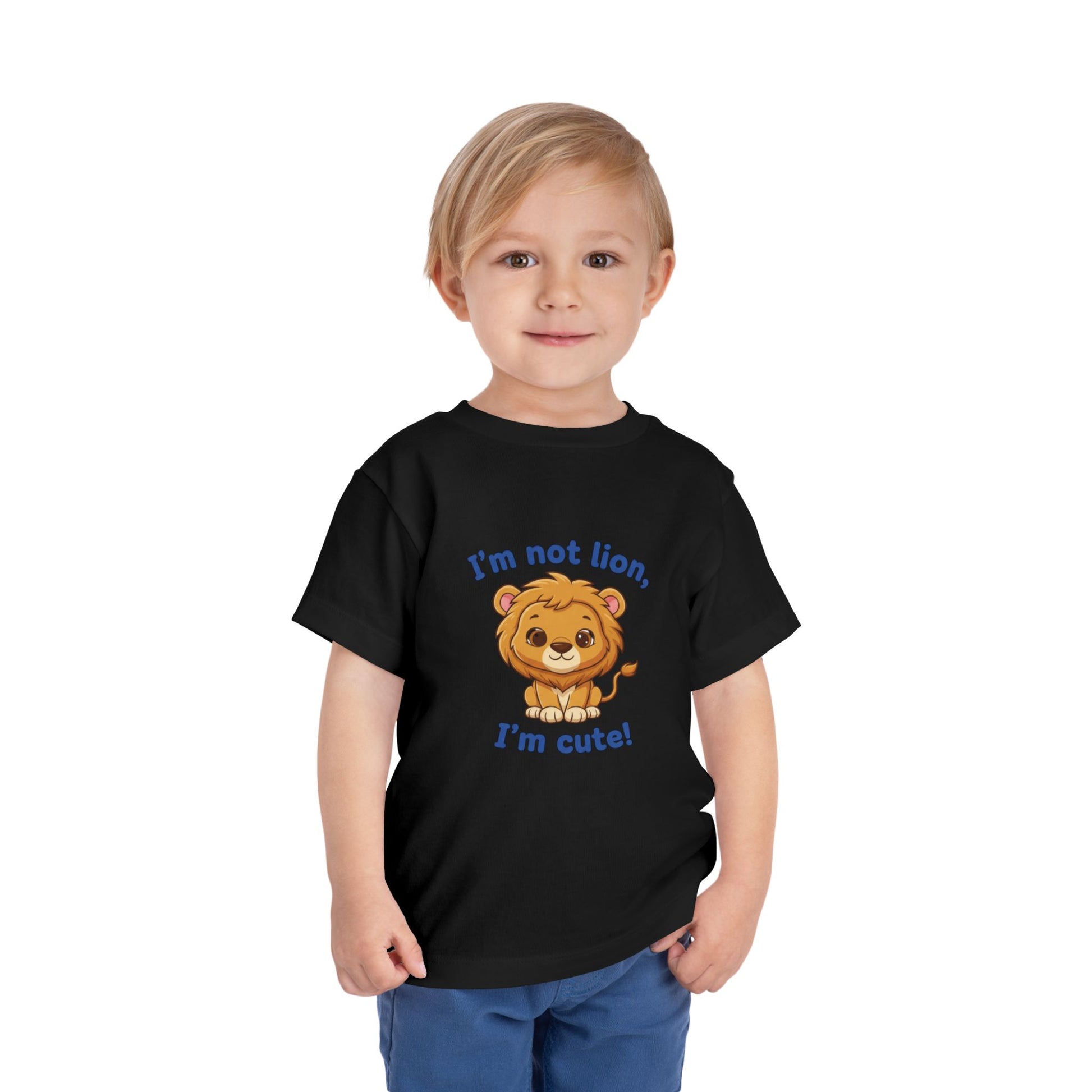 Child wearing a black t-shirt with a lion graphic and text "I'm Not Lion I'm Cute"  Bella+Canvas 3001T on a white background