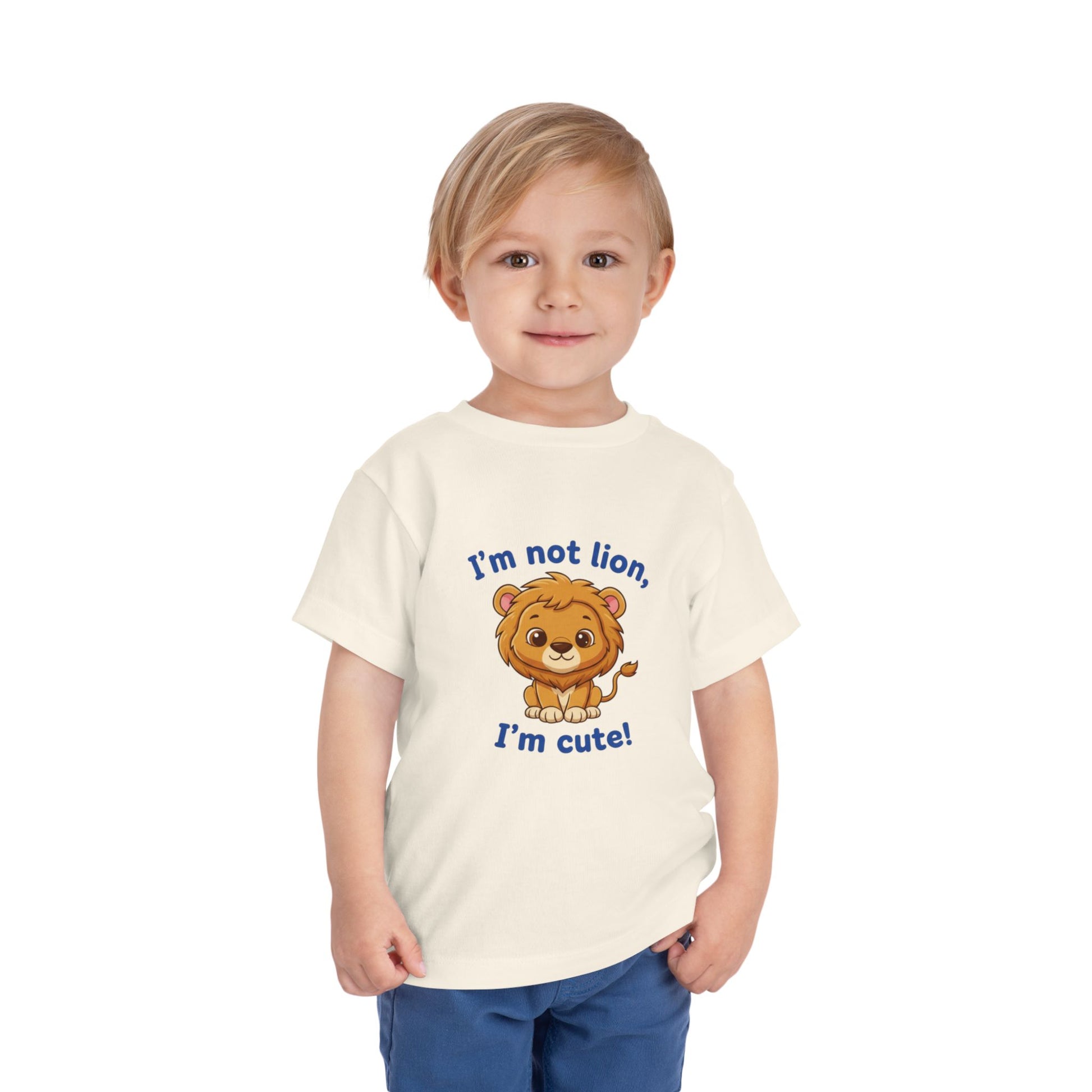 Child wearing a Neutral t-shirt with a lion graphic and text "I'm Not Lion I'm Cute"  Bella+Canvas 3001T on a white background