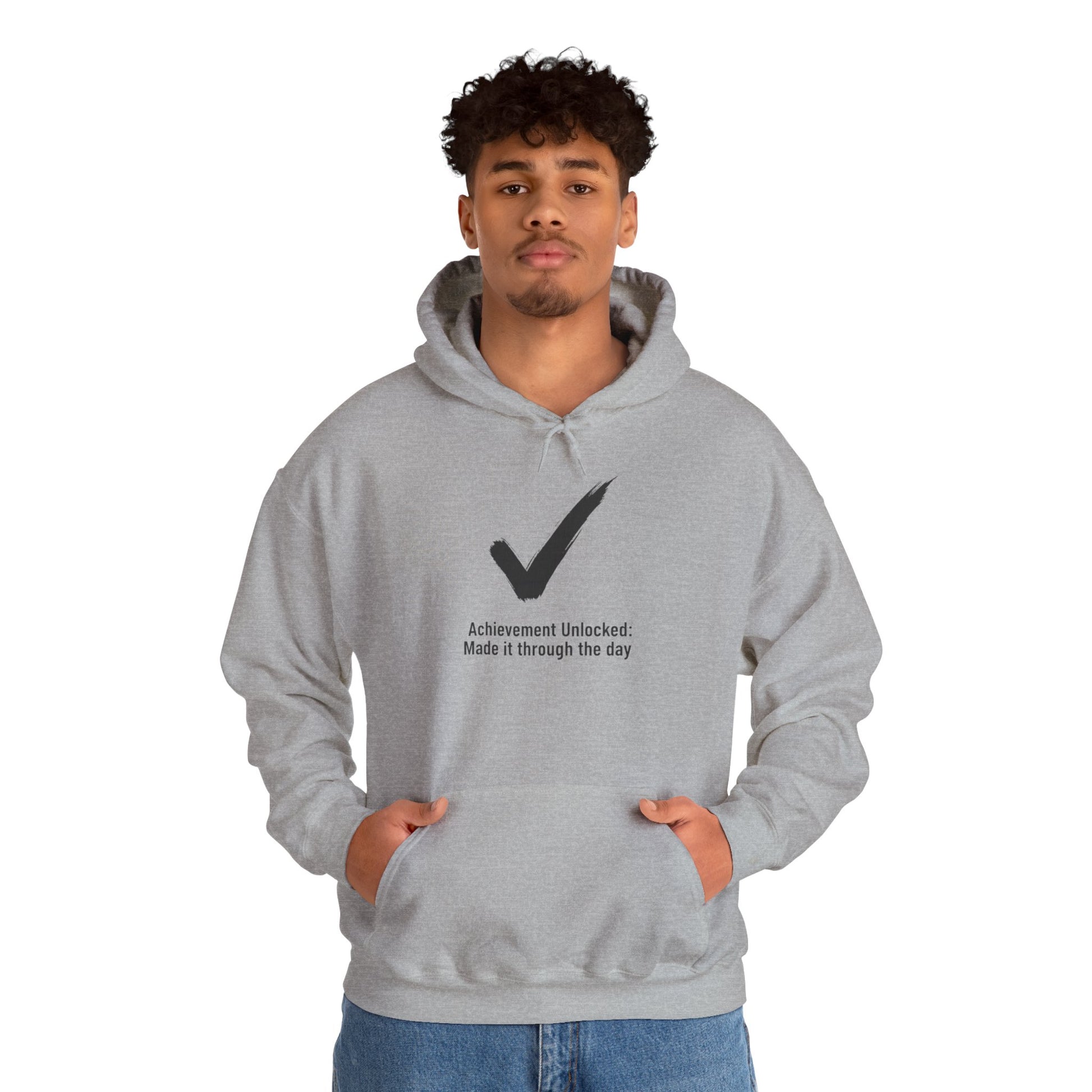 Person wearing a gray hoodie with a checkmark design and text 'Achievement Unlocked: Made it through the day' on a white background