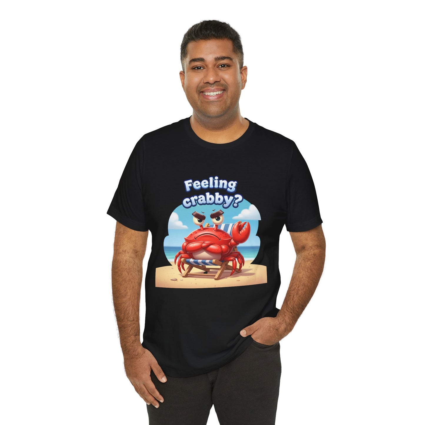 Person wearing a black t-shirt with cartoon crab on the beach with text 'Feeling crabby?'