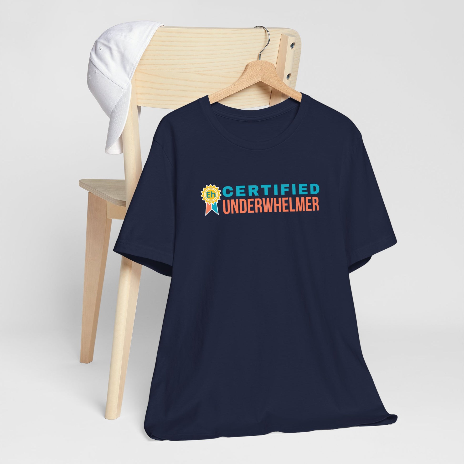 Navy blue t-shirt with 'Certified Underwhelmer' text on a white background