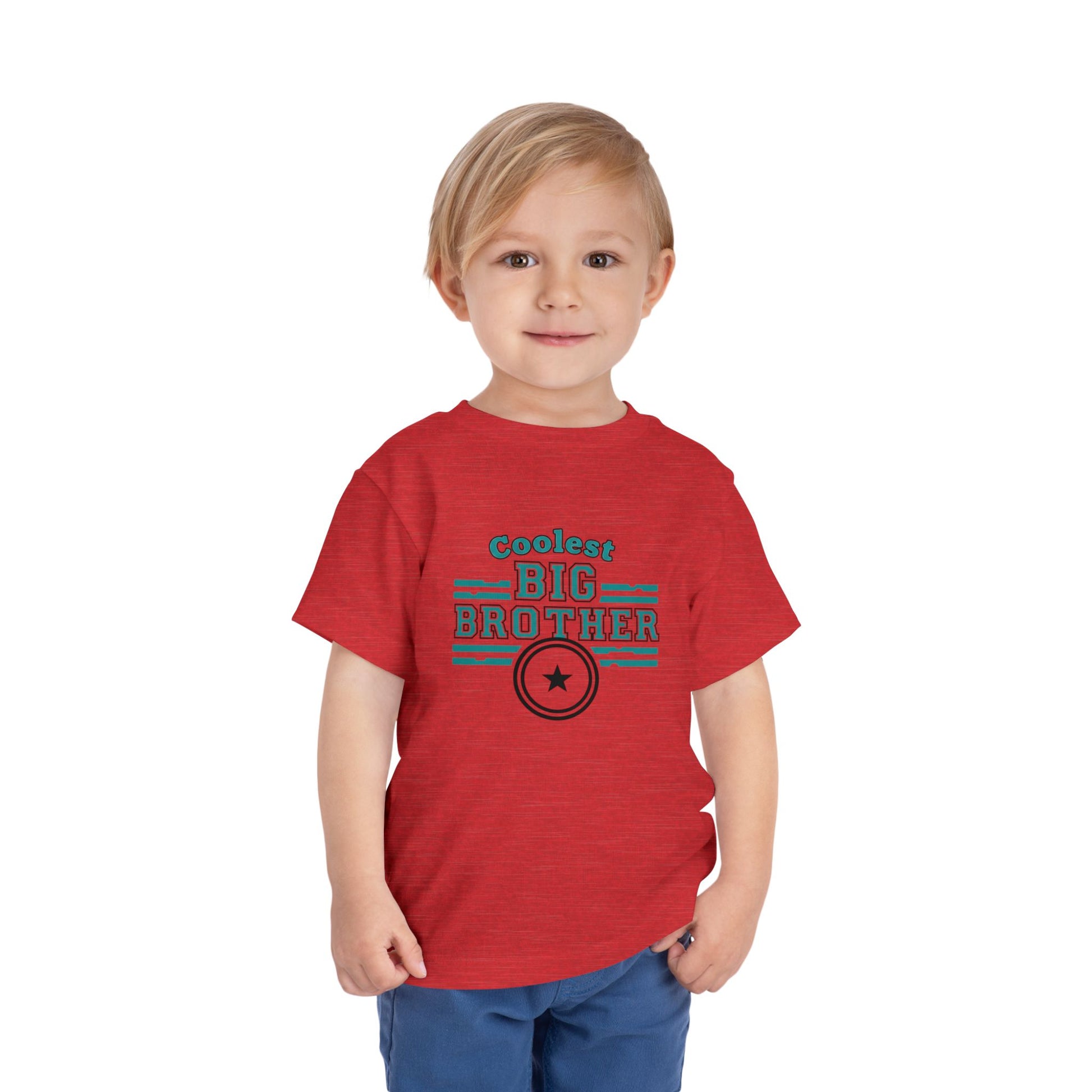 Child wearing a red 'Coolest Big Brother' t-shirt on a white background