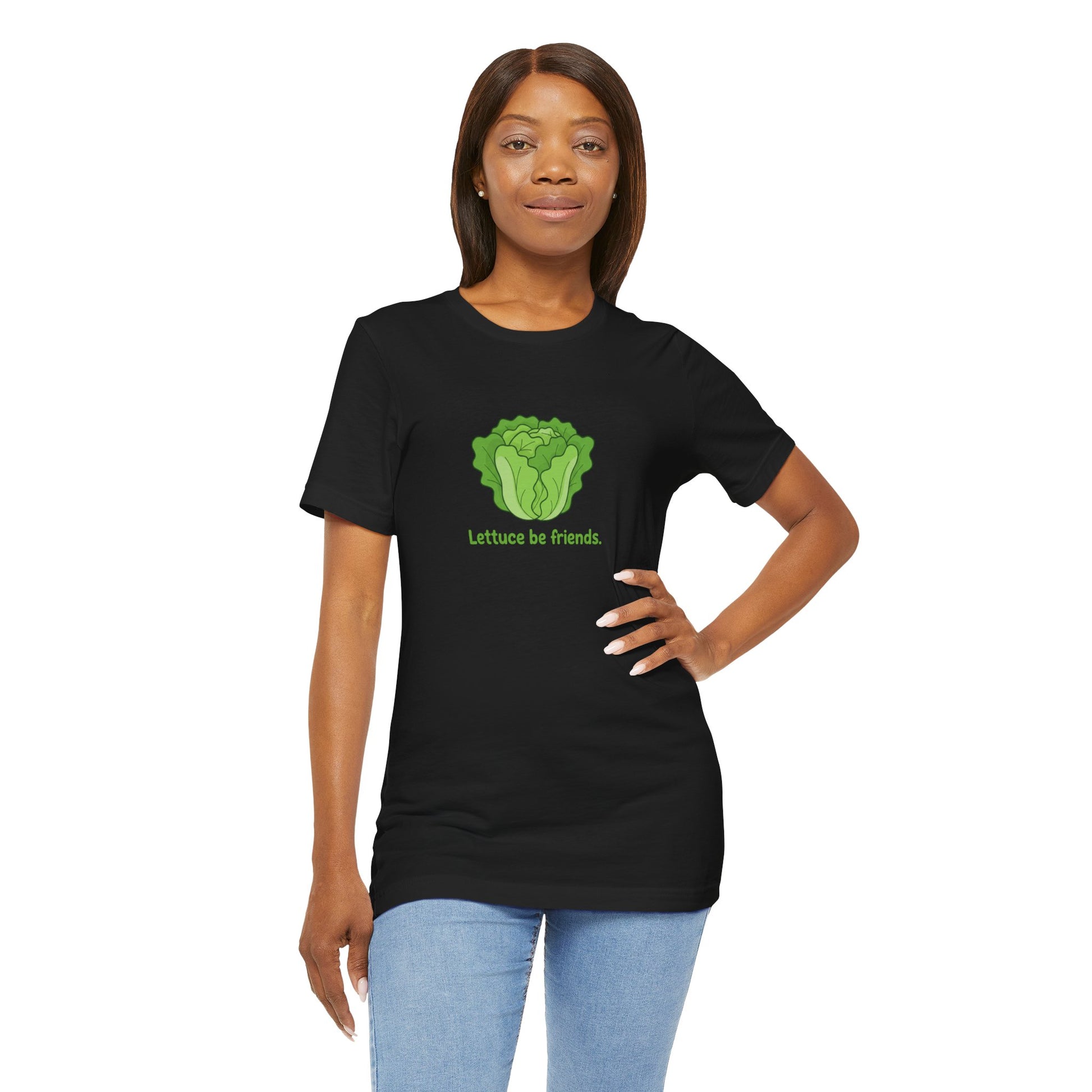 Woman wearing a black t-shirt with a green graphic and text 'Lettice be friends' on a white background