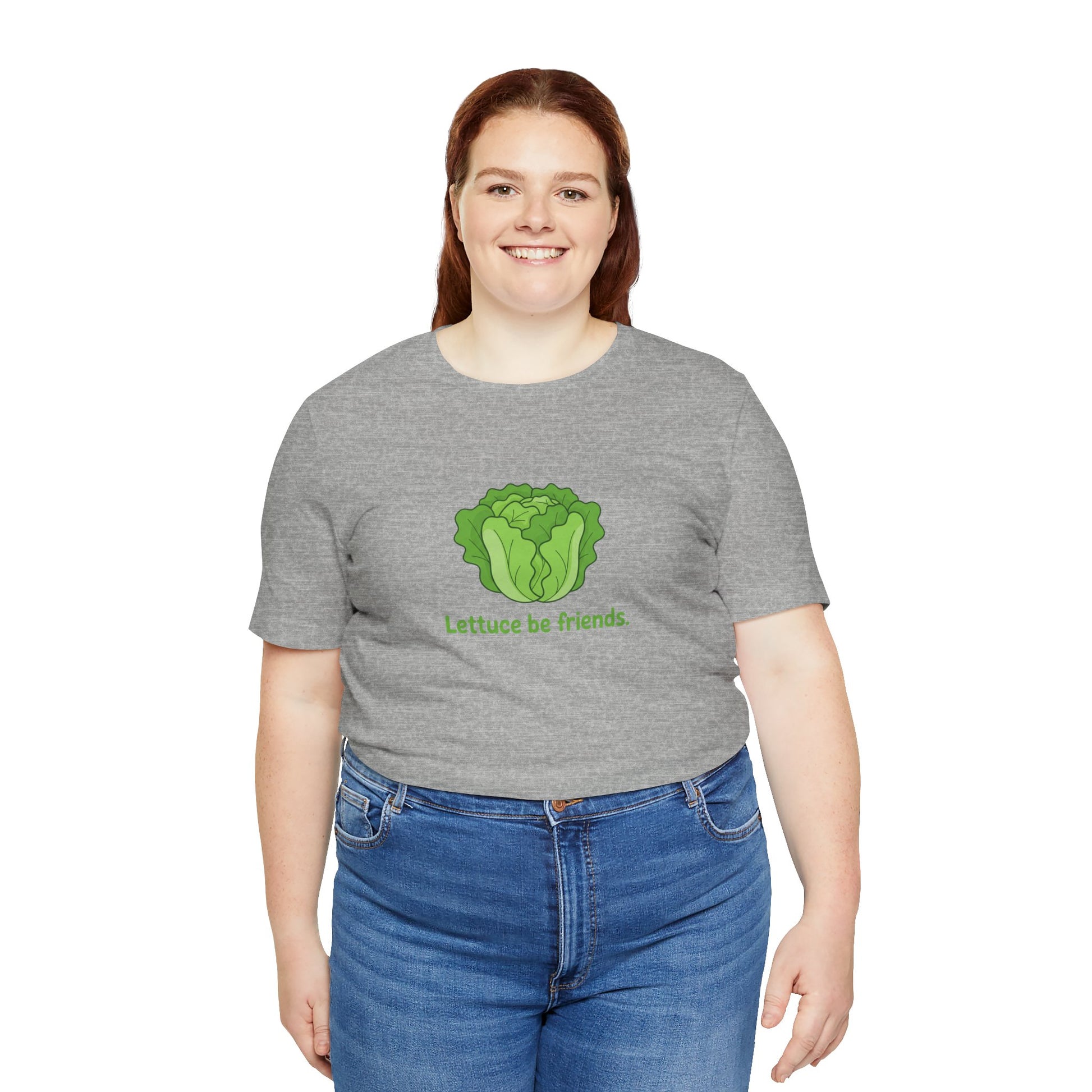 Person wearing a gray t-shirt with a green graphic and text 'Lettuce be friends' on a white background