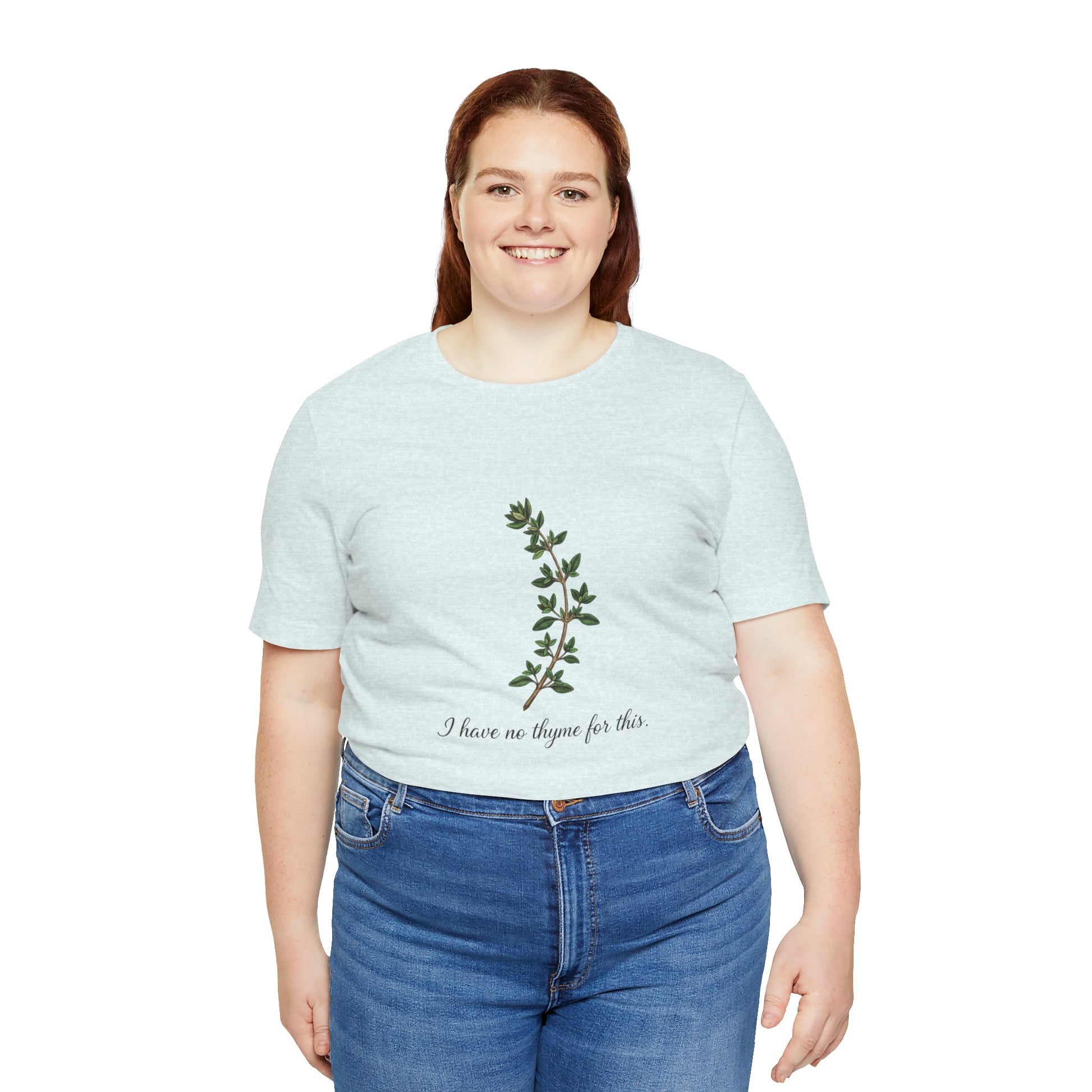 Person wearing a light blue t-shirt with a plant design and text 'I have no thyme for this' on a white background