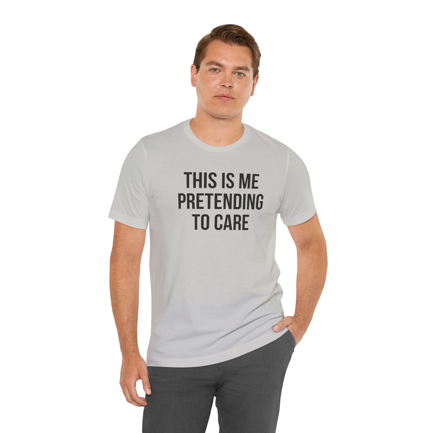 Man wearing a gray t-shirt with text 'THIS IS ME PRETENDING TO CARE' on a white background