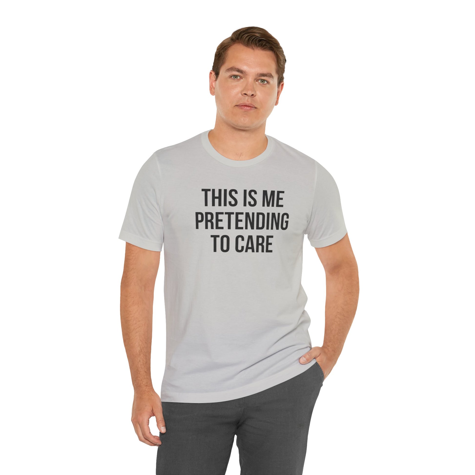 Man wearing a gray t-shirt with text 'THIS IS ME PRETENDING TO CARE' on a white background