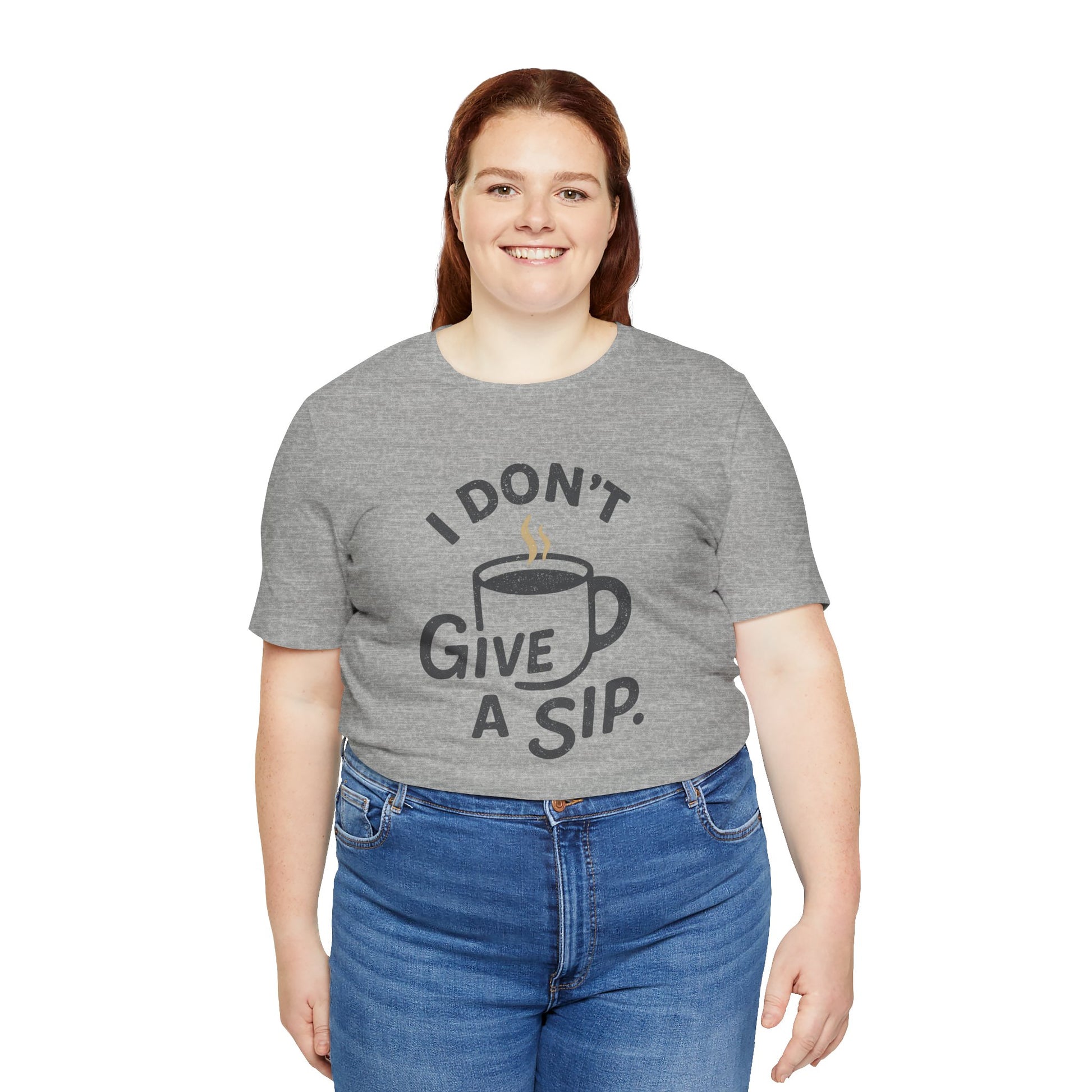 Person wearing a gray t-shirt with a coffee-themed design and 'I don't give a sip' text on a white background
