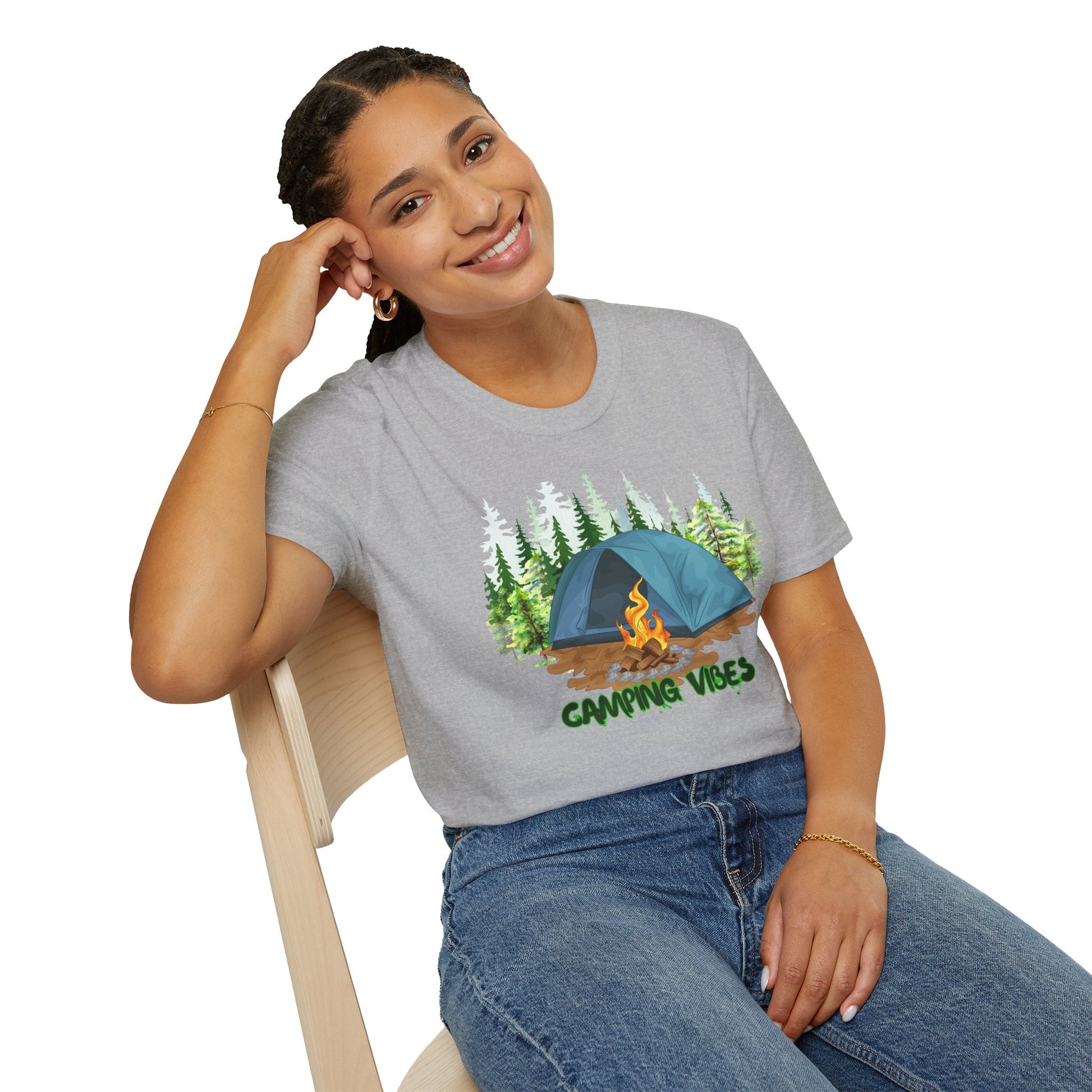 Person wearing a gray t-shirt with a camping graphic and text, sitting on a chair.