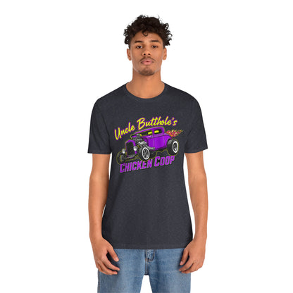 Person wearing a heather navy Bella+Canvas 3001 t-shirt with a graphic design and text 'Uncle Butthole's Chicken Coop' on a white background