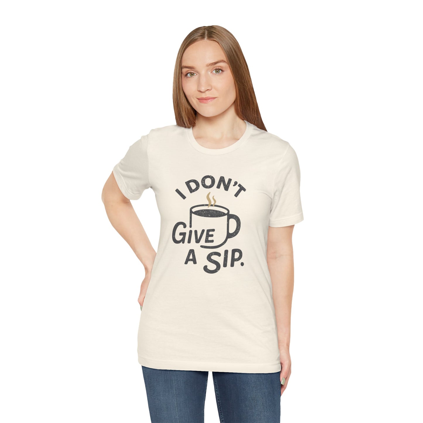 Woman wearing a cream t-shirt with a coffee-themed graphic and 'I don't give a sip' text on a white background