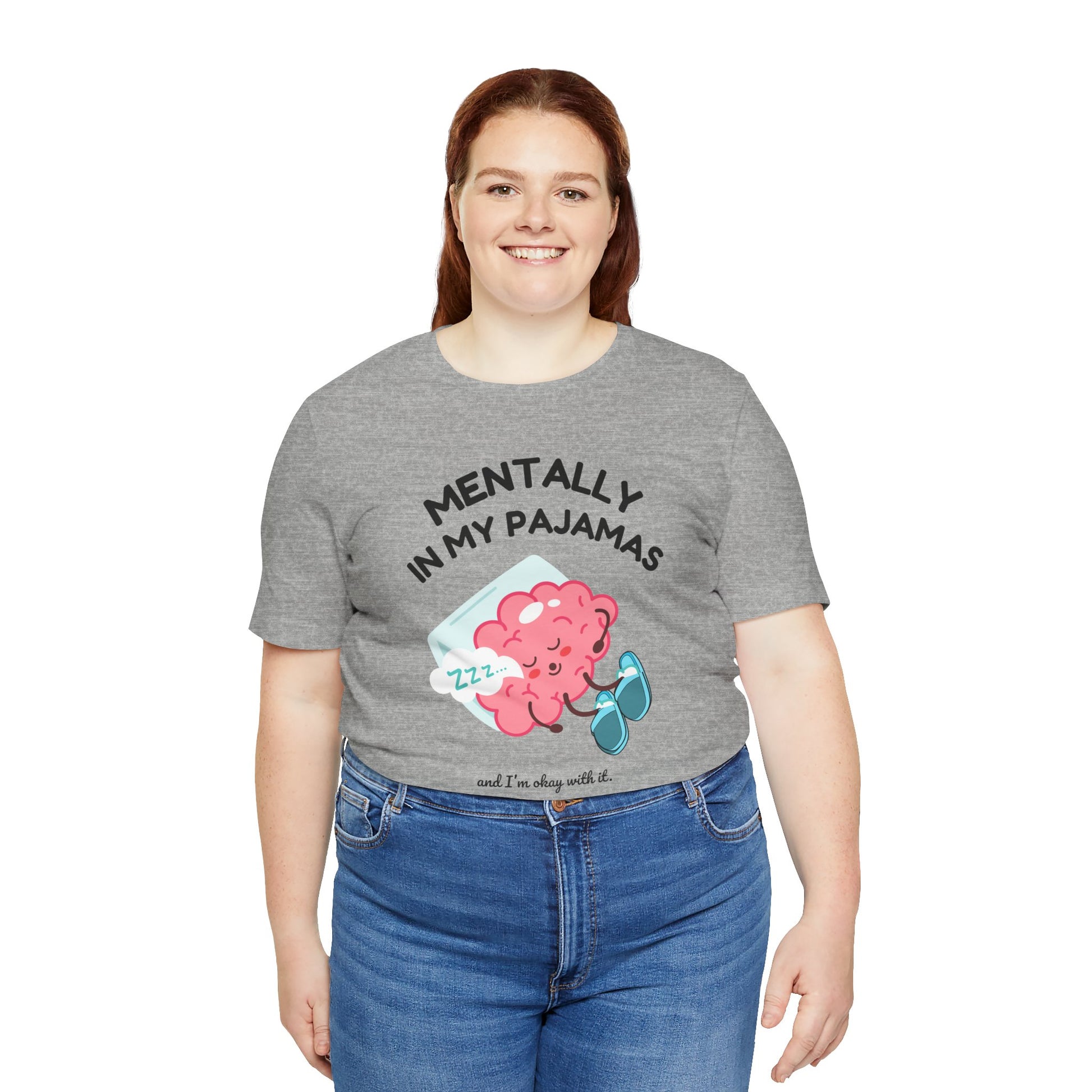 Person wearing a gray t-shirt with a graphic and text 'Mentally in my pajamas and I'm ok with it' on a white background
