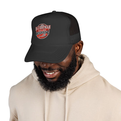 Man wearing a black cap with a logo McFARTMAN Racing We have the gas to make you go fast on a white background