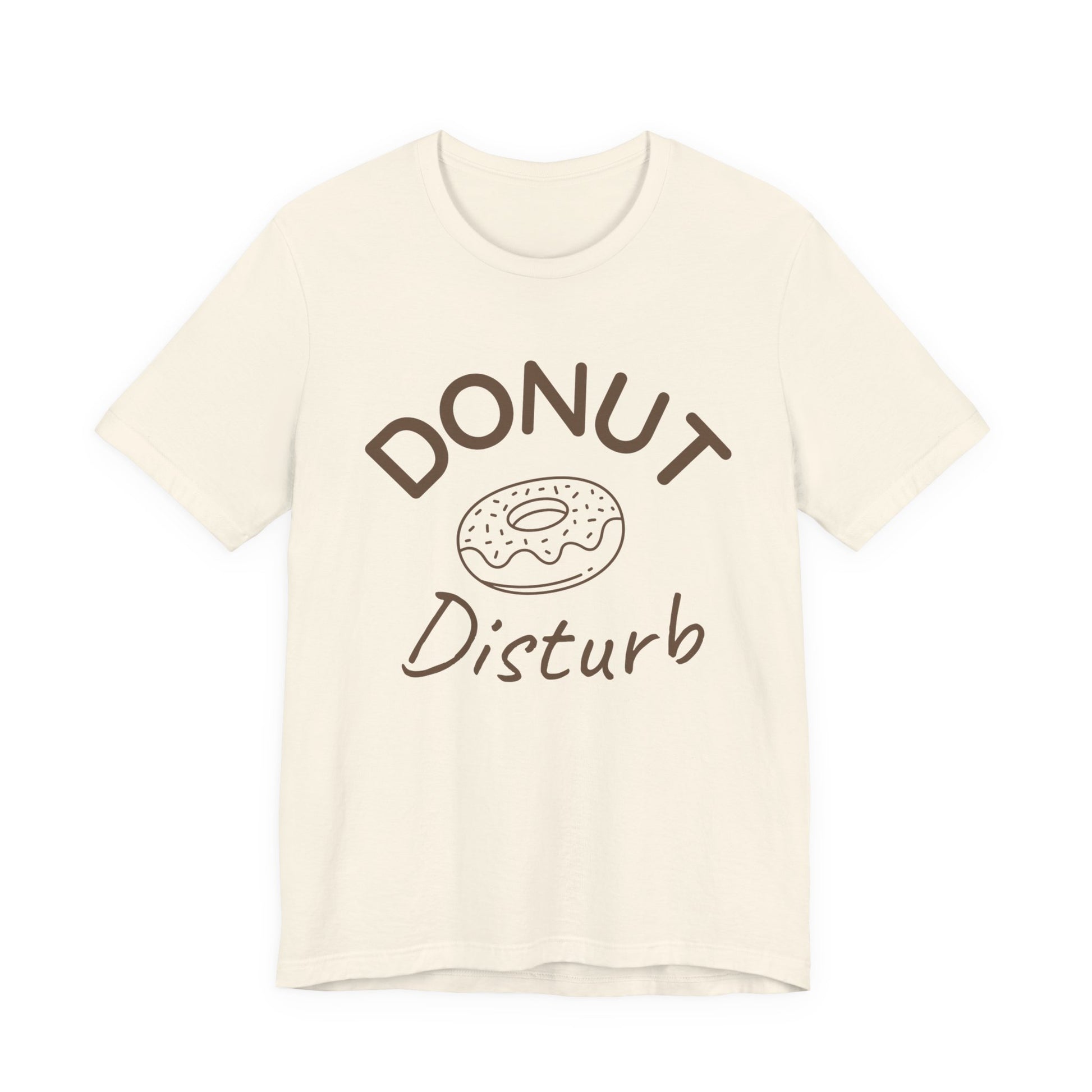 Beige t-shirt with 'DONUT Disturb' text and donut graphic on a white background