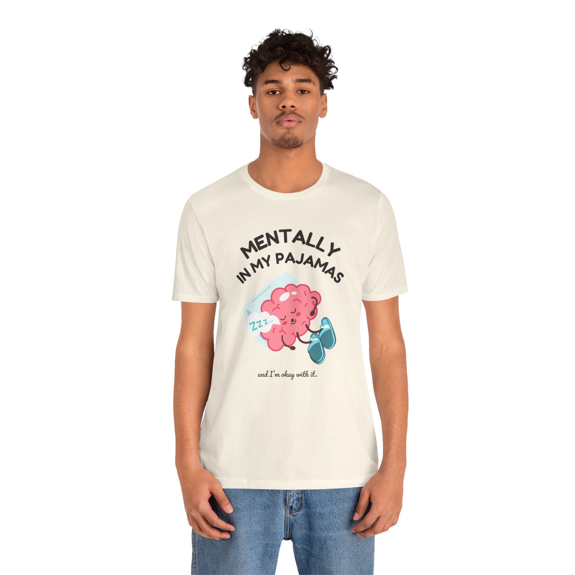 Person wearing a white t-shirt with a graphic design and text 'Mentally in my pajamas and I'm ok with it' on a white background