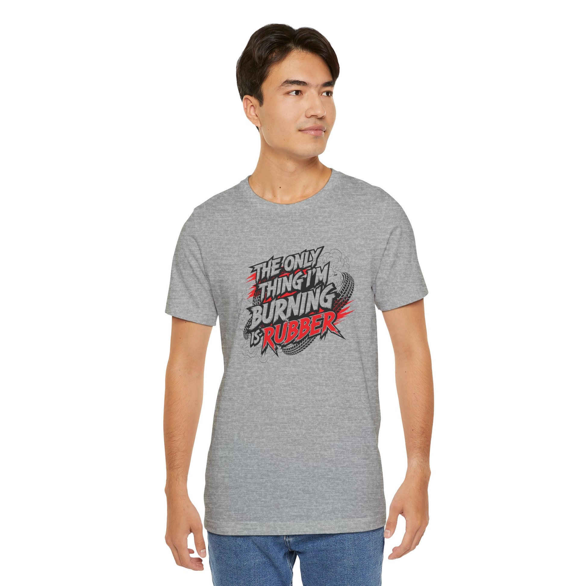 Man wearing a gray t-shirt with a graphic design and text 'The only thing I'm burning is rubber' on a white background