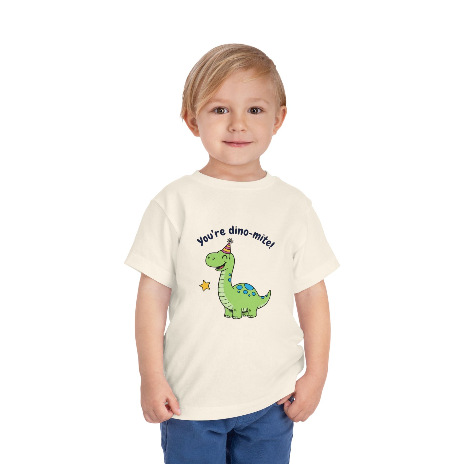 Child wearing a t-shirt with a dinosaur graphic and text on a white background