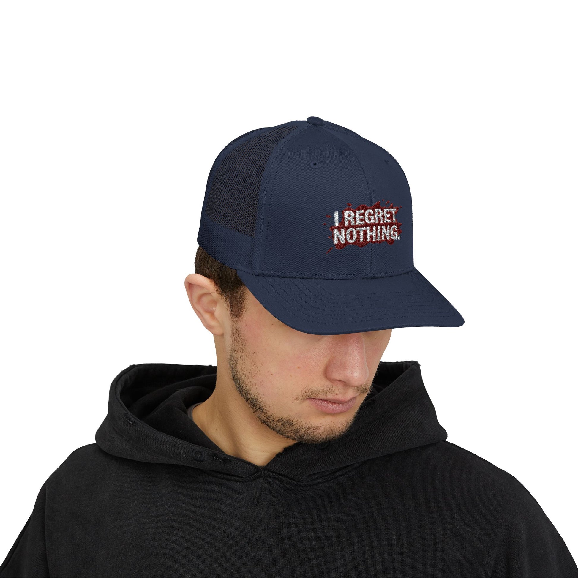 Person wearing a navy cap with 'I Regret Nothing' text on a white background