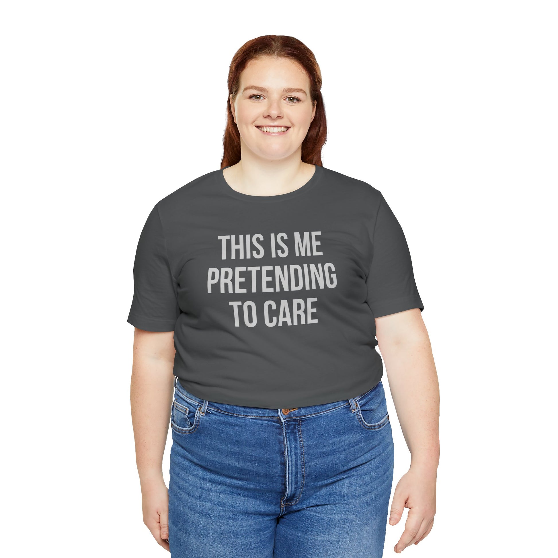 Person wearing a gray t-shirt with text 'This is me pretending to care' on a white background