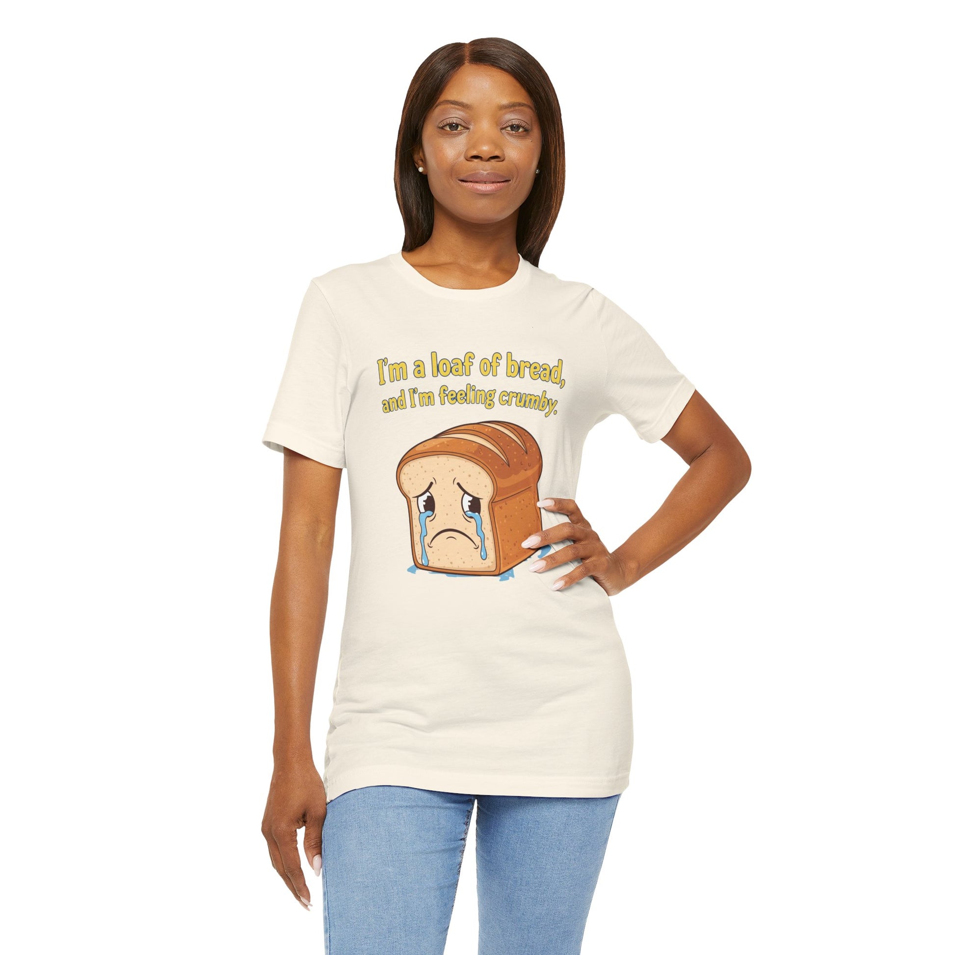 Woman wearing a white t-shirt with a bread graphic and text, standing against a white background. The text says, "I'm a loaf of bread, and I'm feeling crumby"