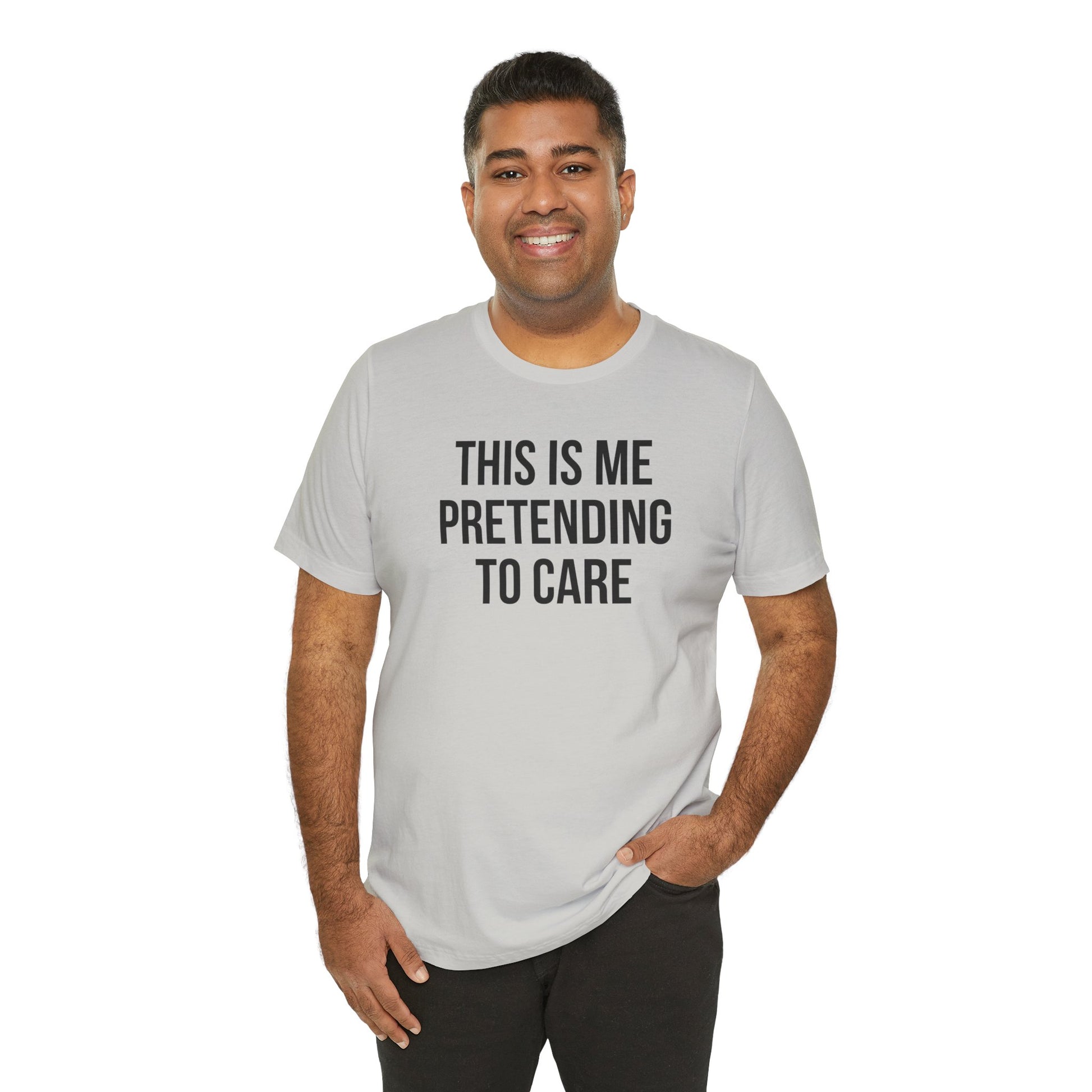 Man wearing a gray t-shirt with text 'THIS IS ME PRETENDING TO CARE' on a white background