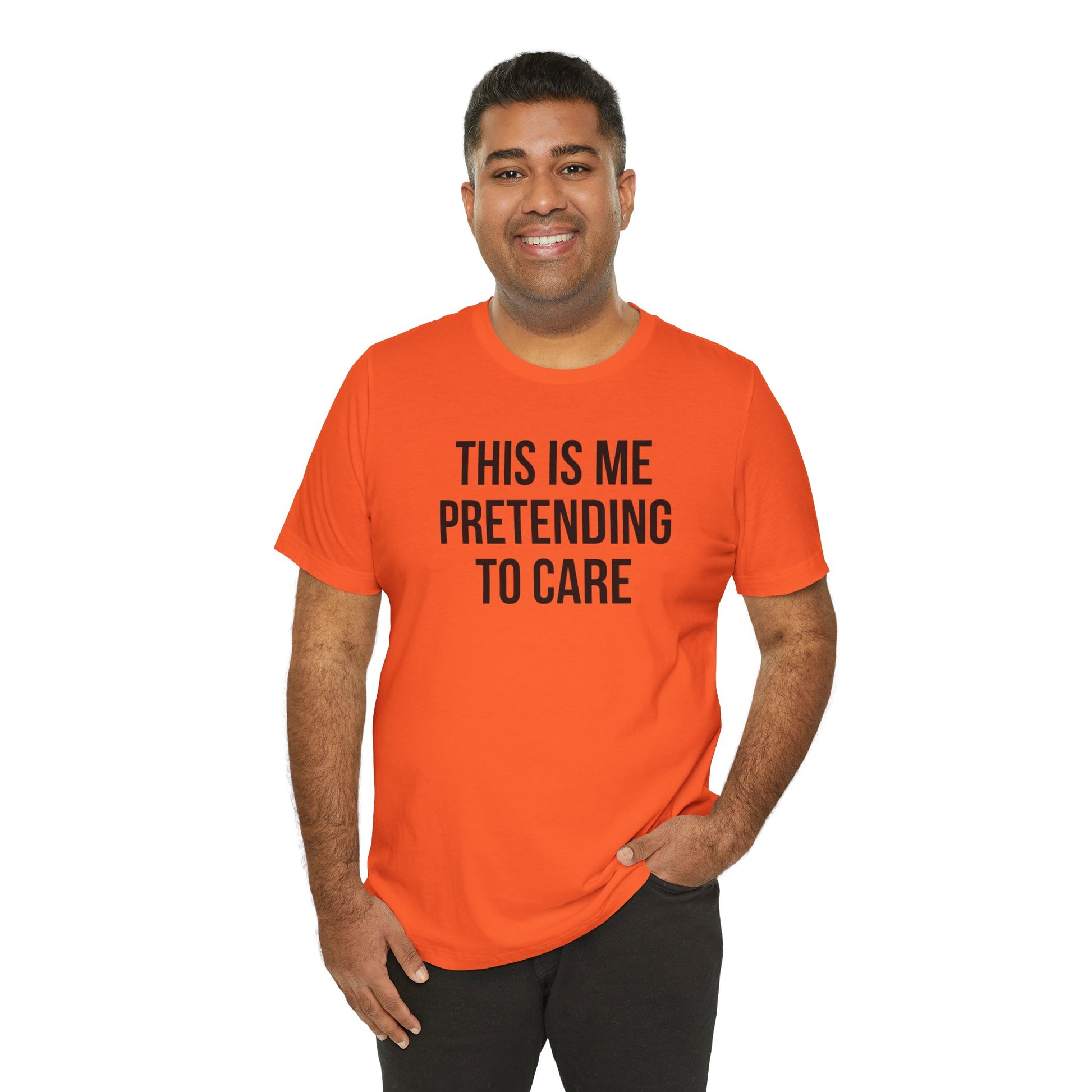 Man wearing an orange t-shirt with text 'This is me pretending to care' on a white background